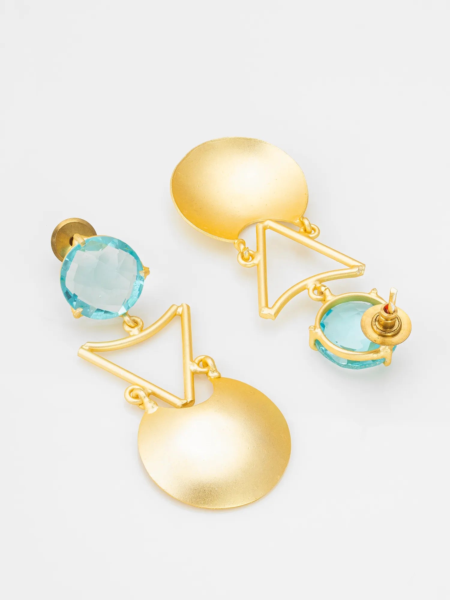 A pair of gold geometric dangle earrings with light blue faceted gemstone accents, displayed on a clean white background.