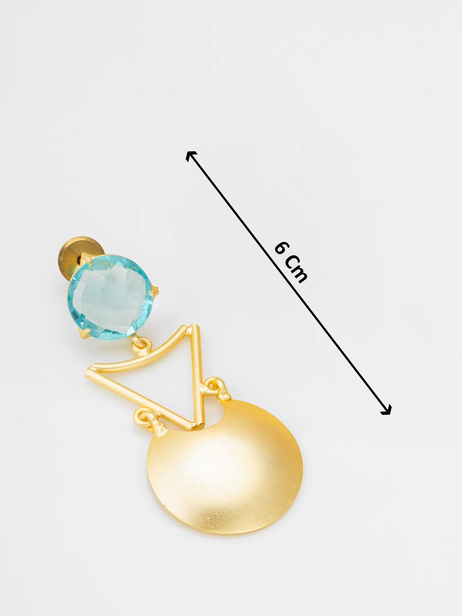 A gold-toned statement earring with a light blue faceted gemstone and a large flat gold disc, shown on a light gray background with a black dimension arrow labeled 6 Cm.