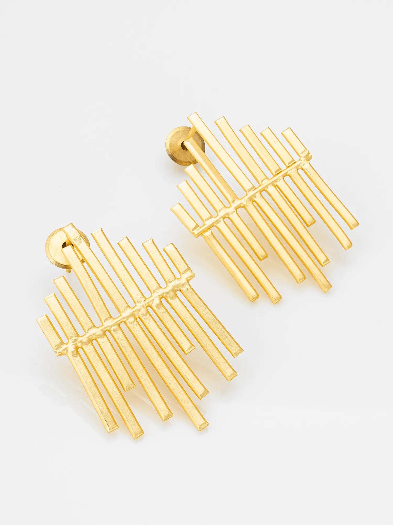 A pair of gold geometric drop earrings with multiple parallel bar elements and a textured center detail, shown on a clean white background.