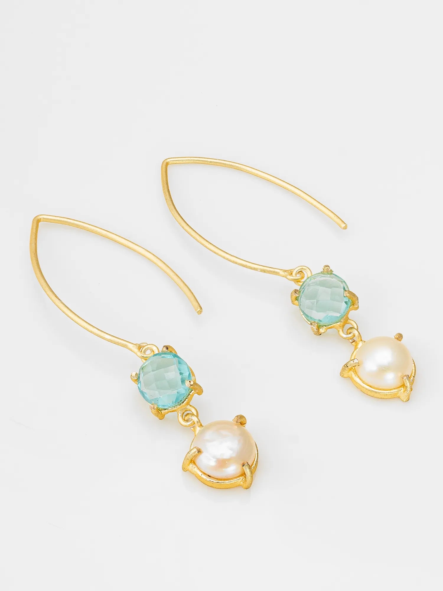 A pair of gold dangle earrings featuring a round light blue-green gemstone and a dangling white pearl, set against a clean white background.