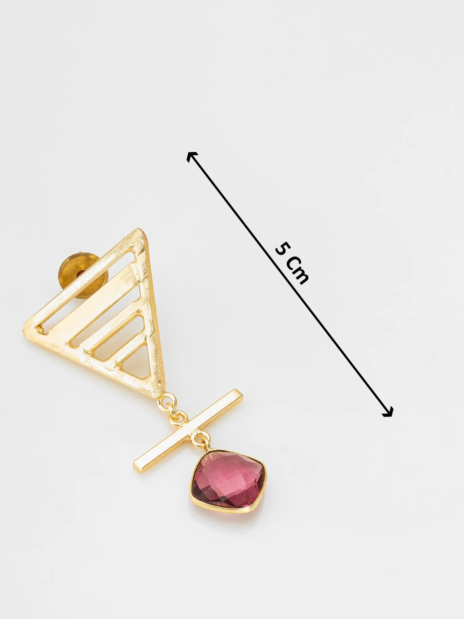 Gold geometric dangle earring with a triangular openwork top, a horizontal bar, and a faceted pink gemstone drop, shown on a light gray background with a 5 cm length indicator.