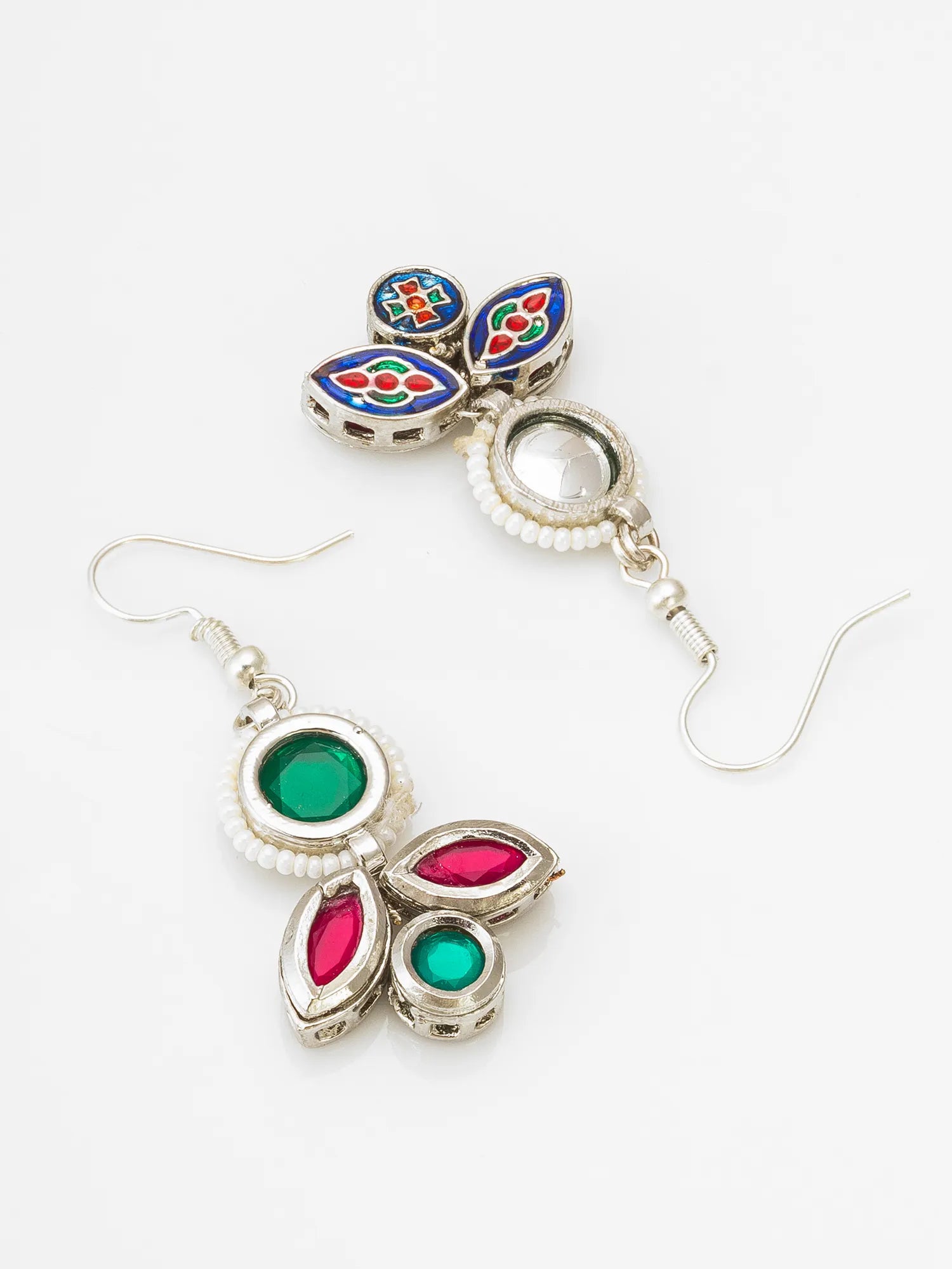 A pair of silver-toned traditional Indian earrings with colorful enamel and stone details, displayed on a clean white background.