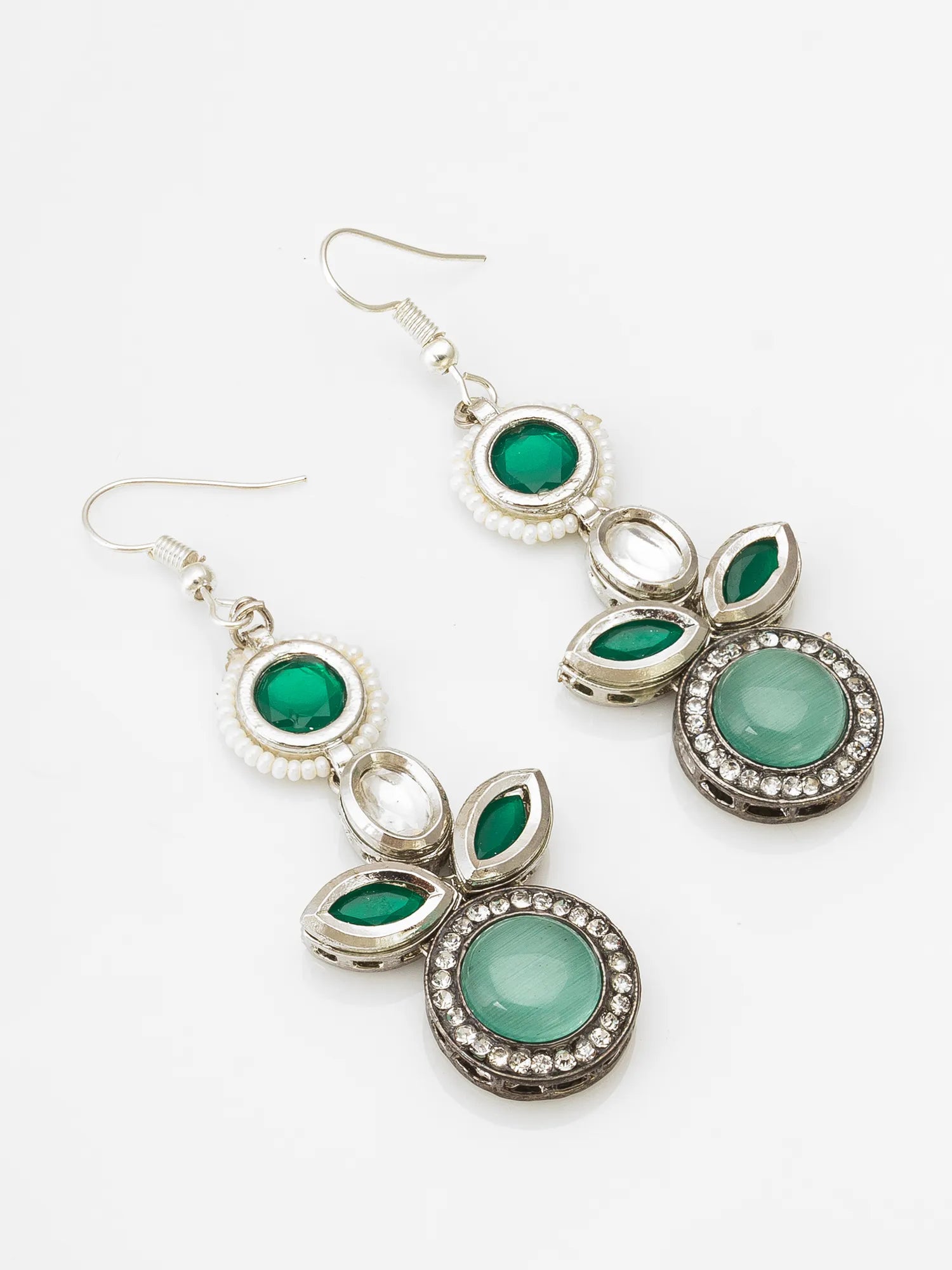 A pair of silver dangle earrings featuring green gemstone details, set against a plain white background.