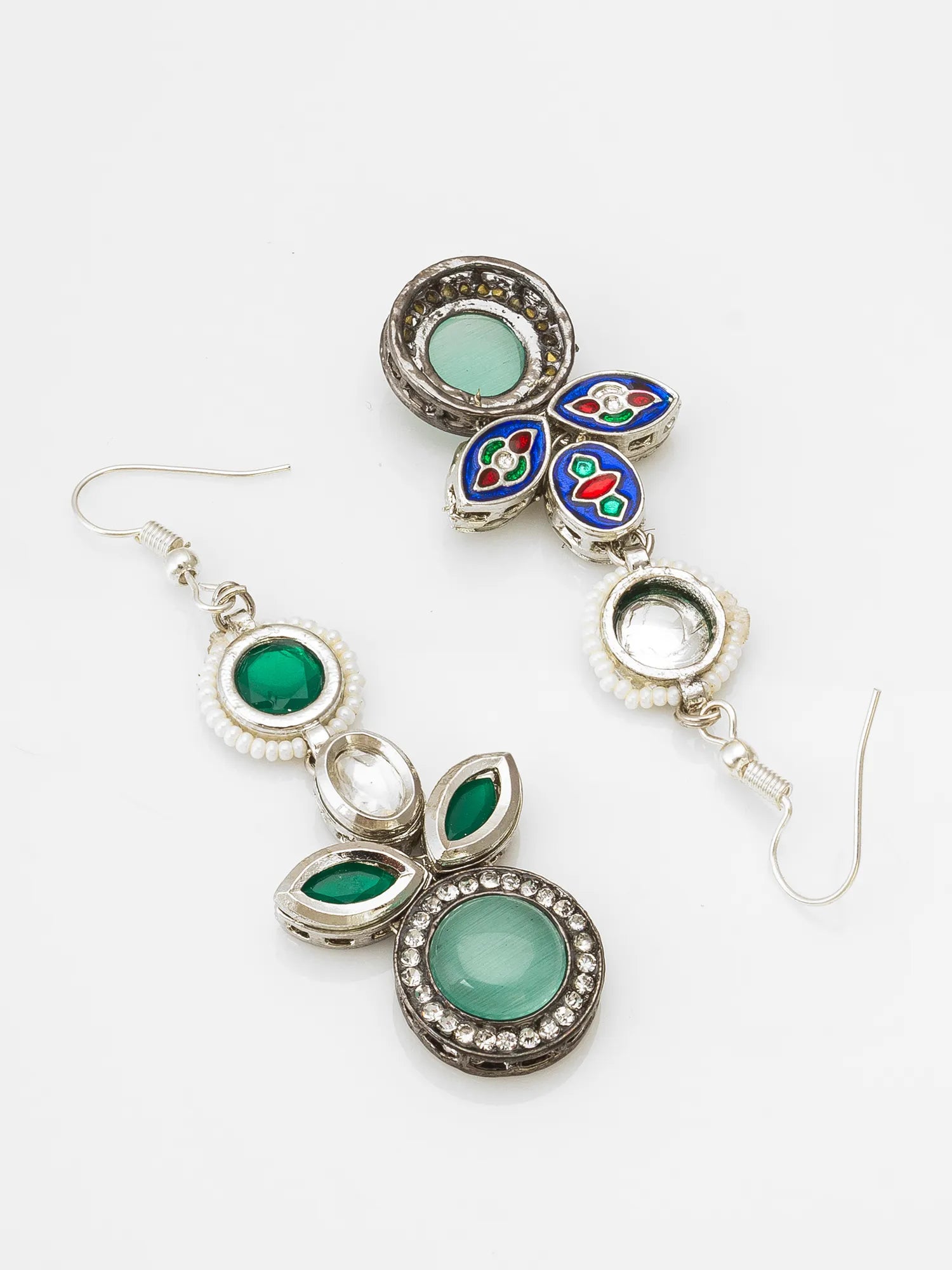 Silver earrings with green gemstones on a white background