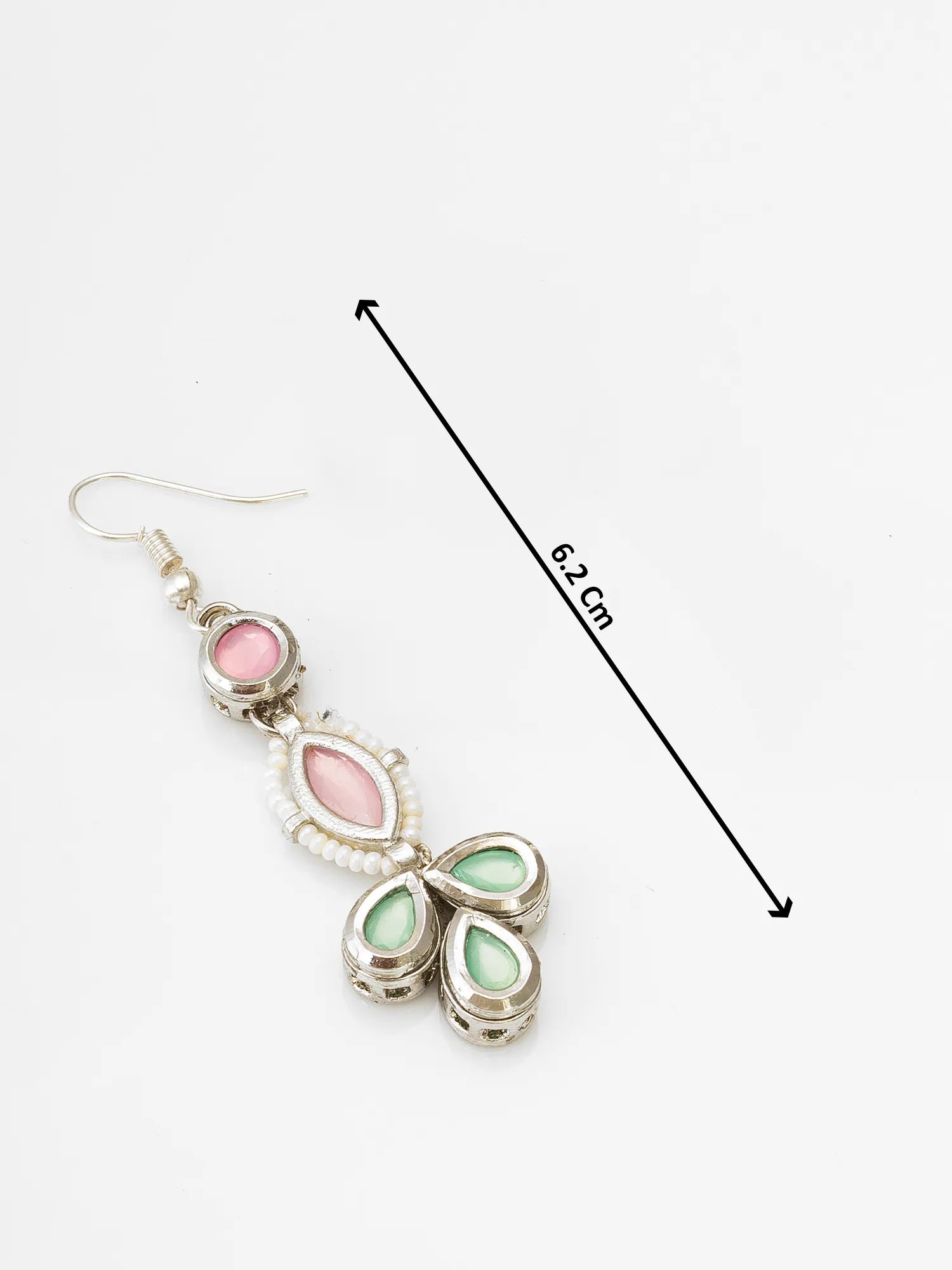 Earrings with pink and green stones and a measurement line on a white background