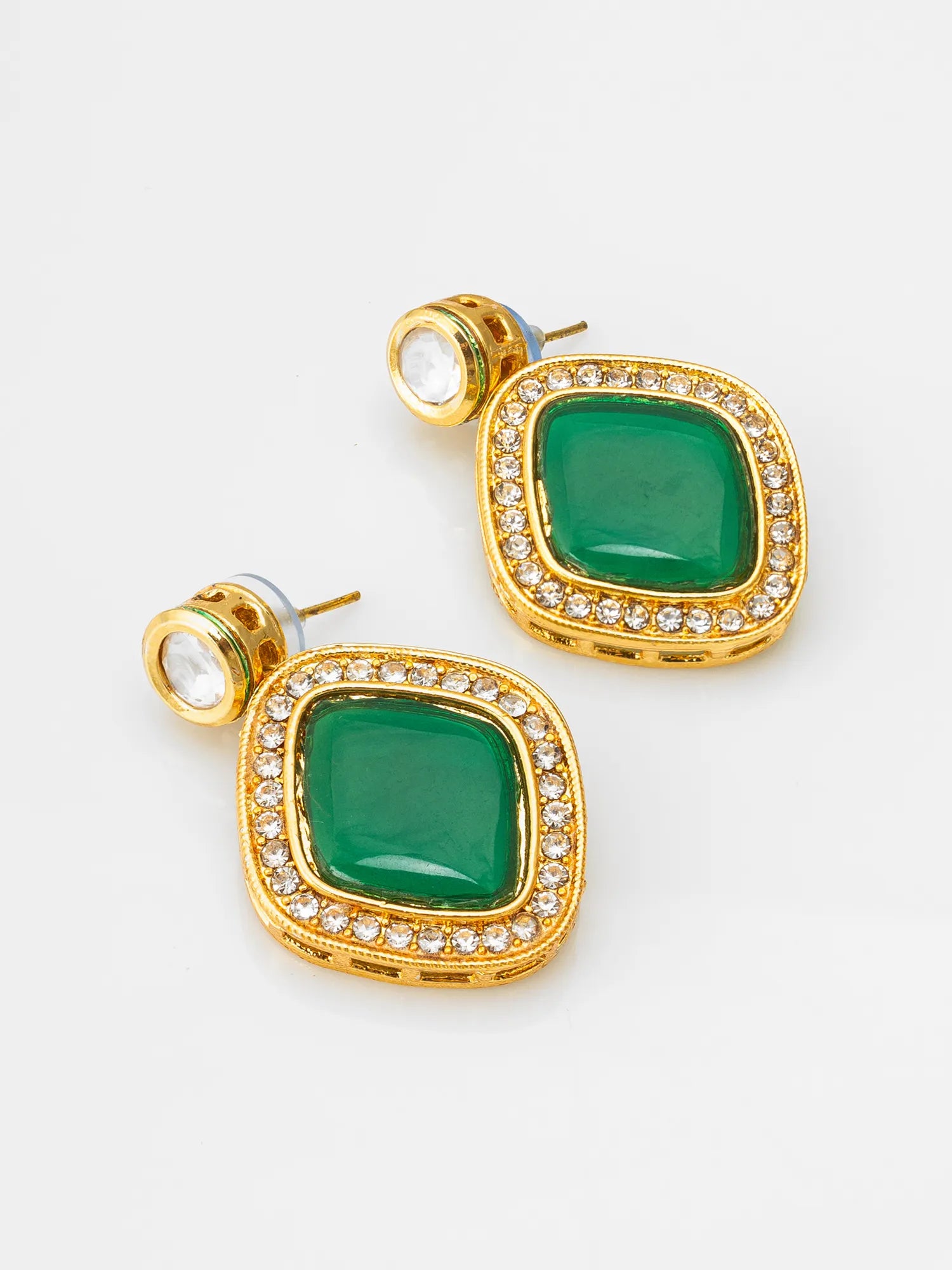 A pair of gold square stud earrings featuring a central green stone surrounded by a border of small clear crystals, shown on a light gray background.