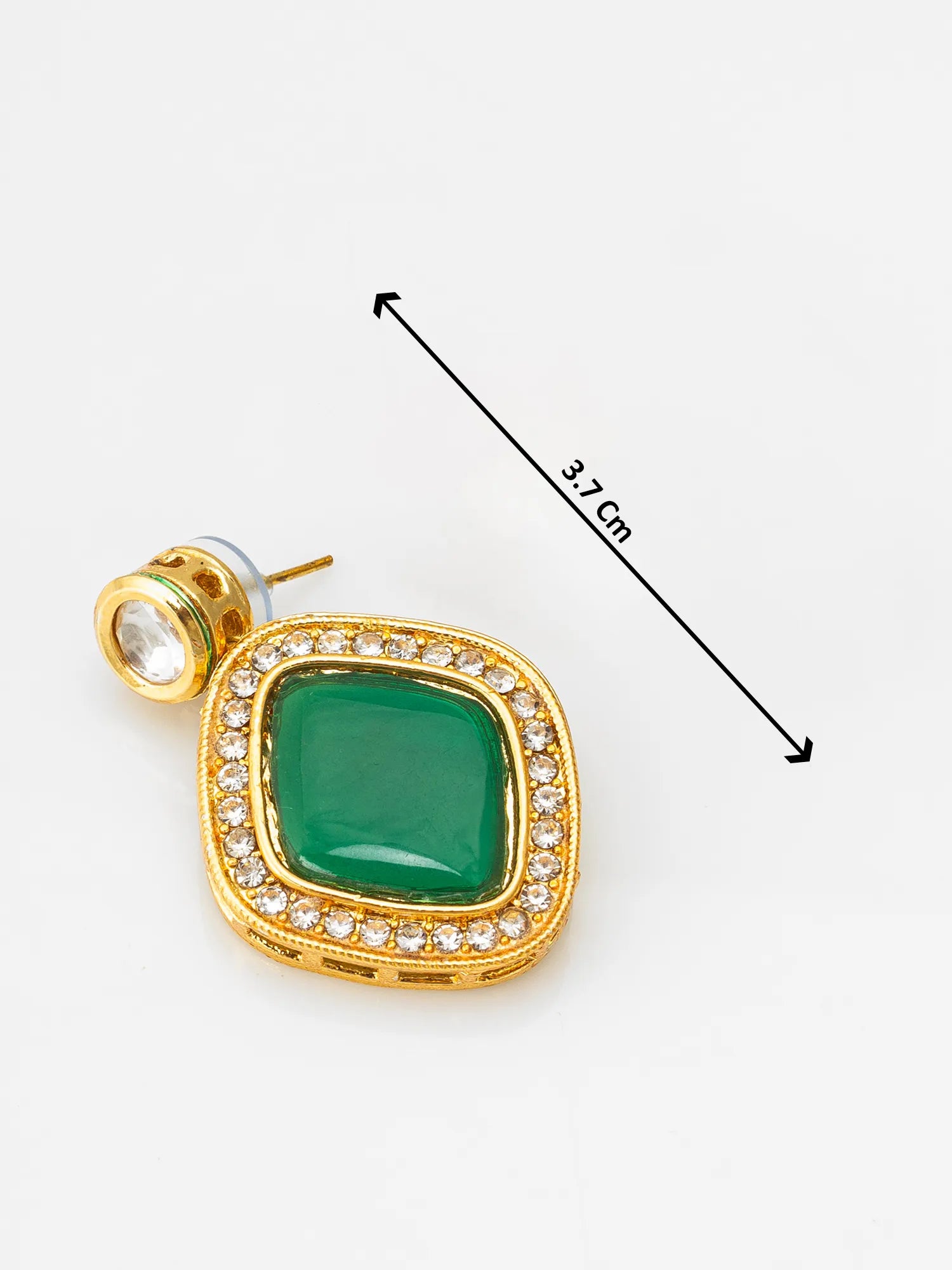 Gold pendant with green gemstone and clear stones on a white background