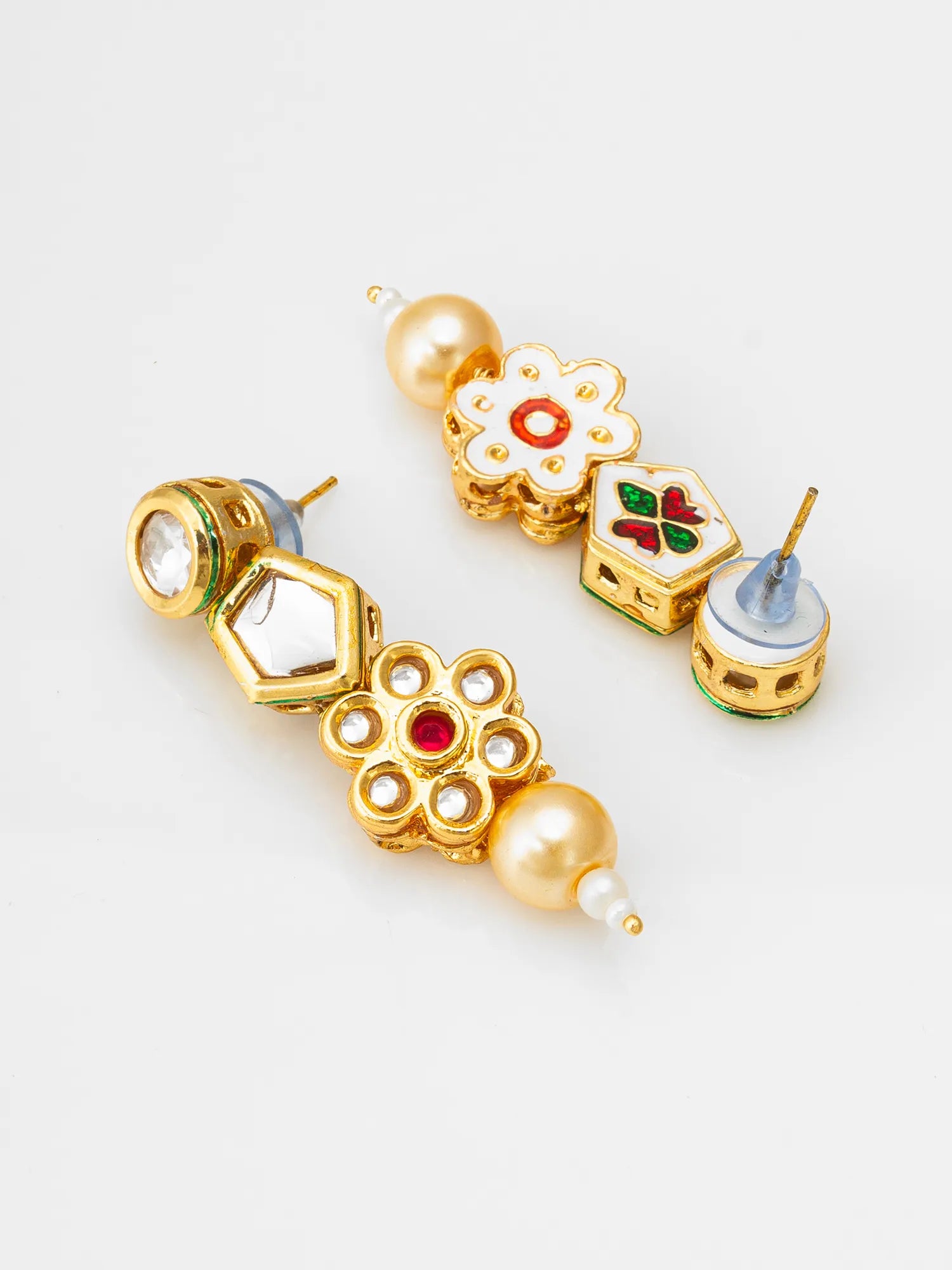 A pair of gold-plated statement earrings featuring white enamel floral and geometric motifs, accented with red, green, and blue enamel details, and white faux pearls, displayed on a clean white background.