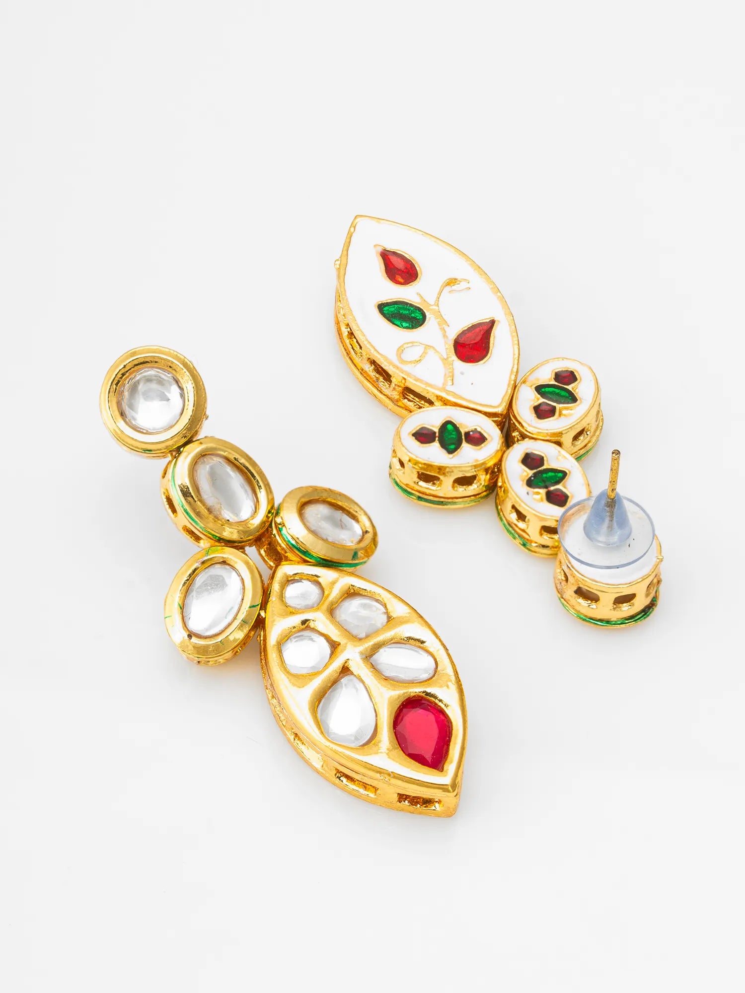 Gold-plated Kundan earrings with white enamel inlays, clear stones, and red and green enamel accents, shown on a white background with one earring displayed front-facing and the other showing the post backing.