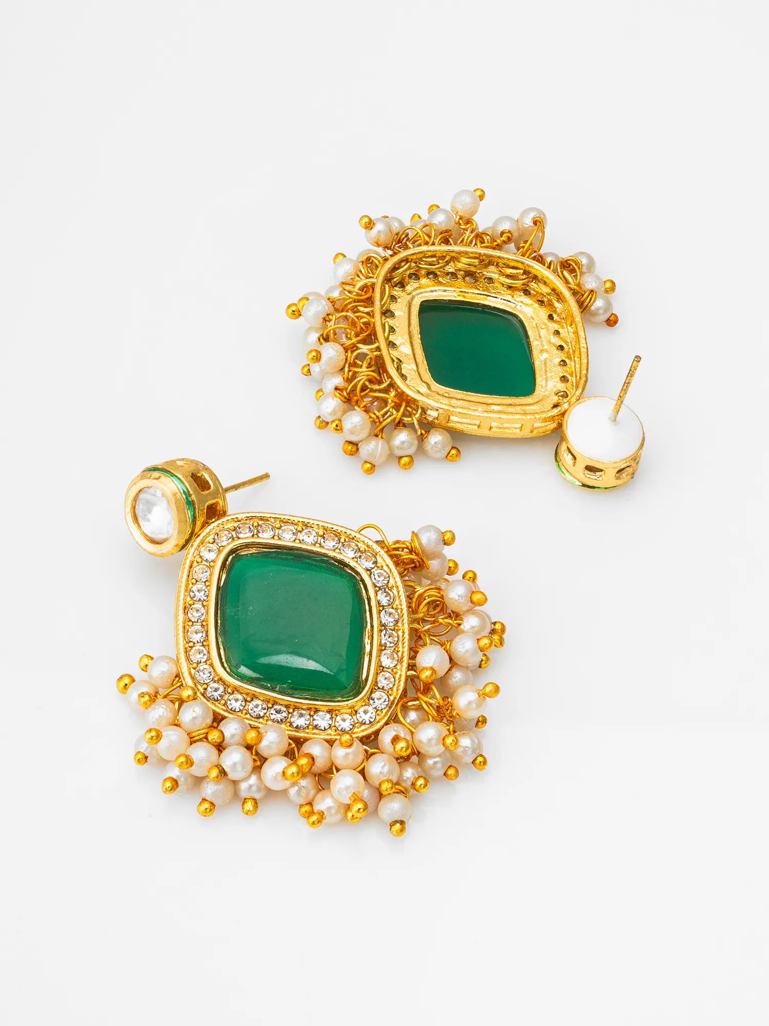 A pair of gold-plated statement earrings featuring a central green stone surrounded by small white pearls and gold beads, set against a plain white background.