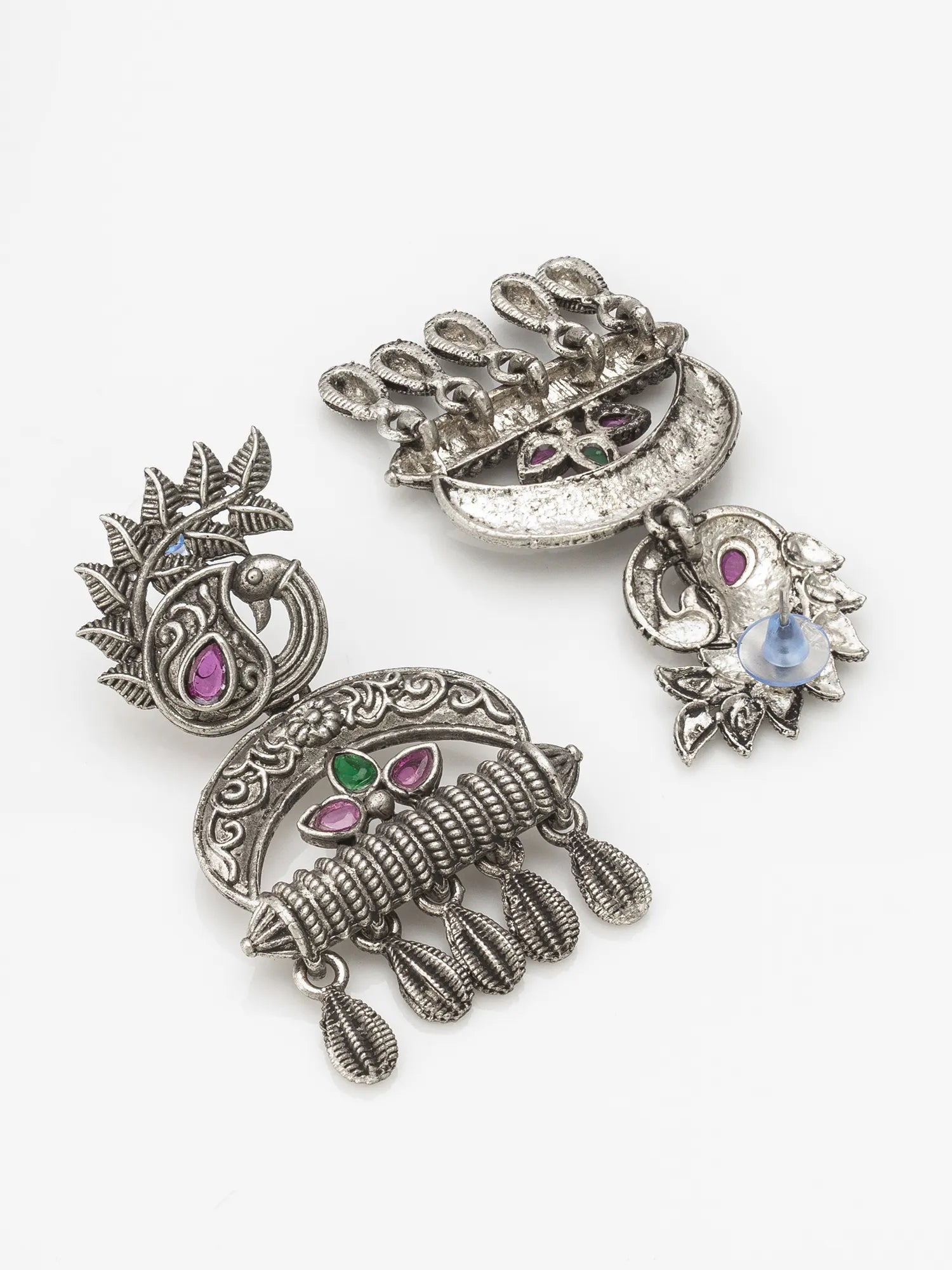 Ornate silver earrings with gemstones on a white background