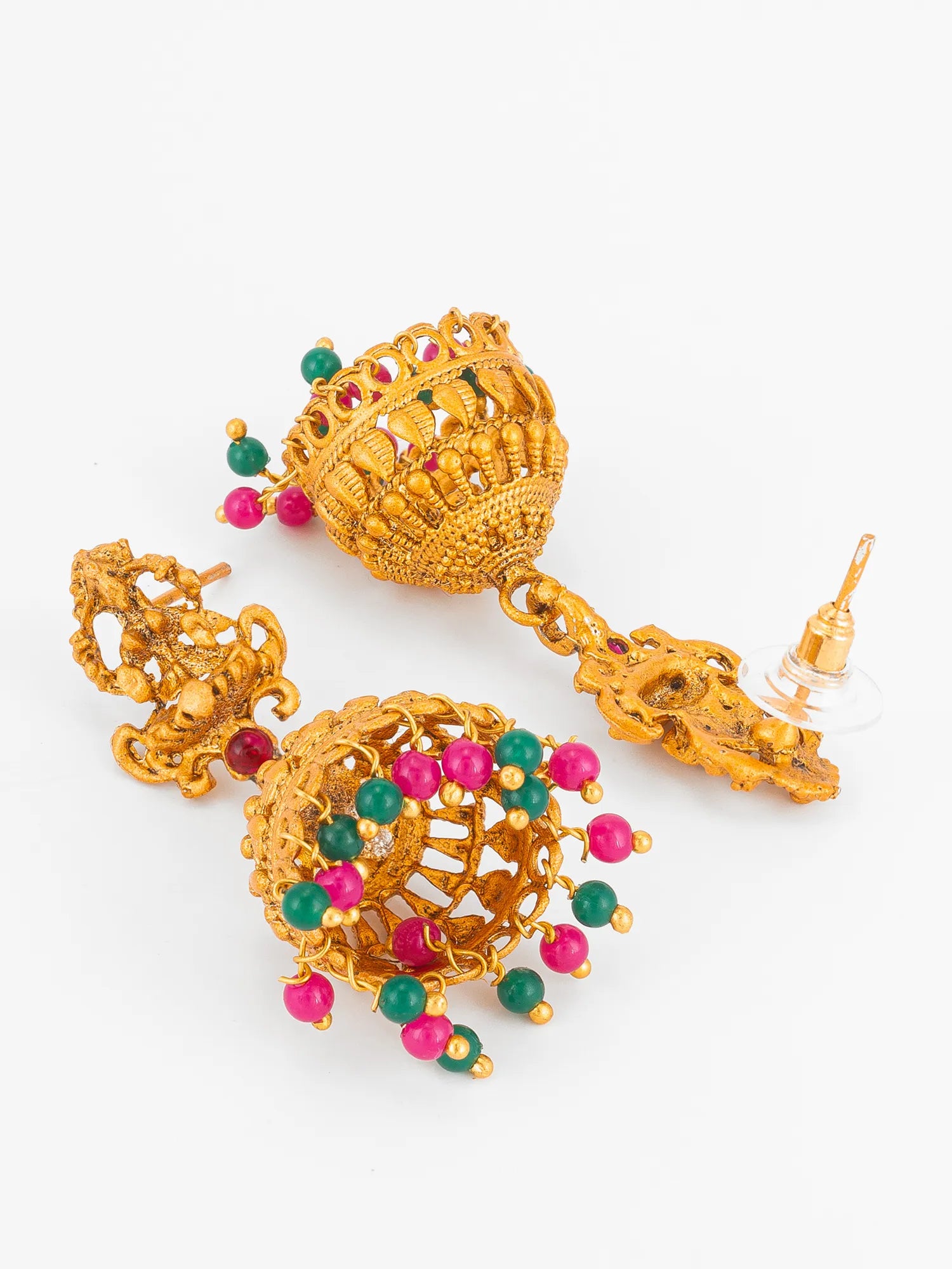 A pair of ornate gold-toned traditional Indian jhumka earrings decorated with small green and pink gemstone beads, displayed on a clean white background.