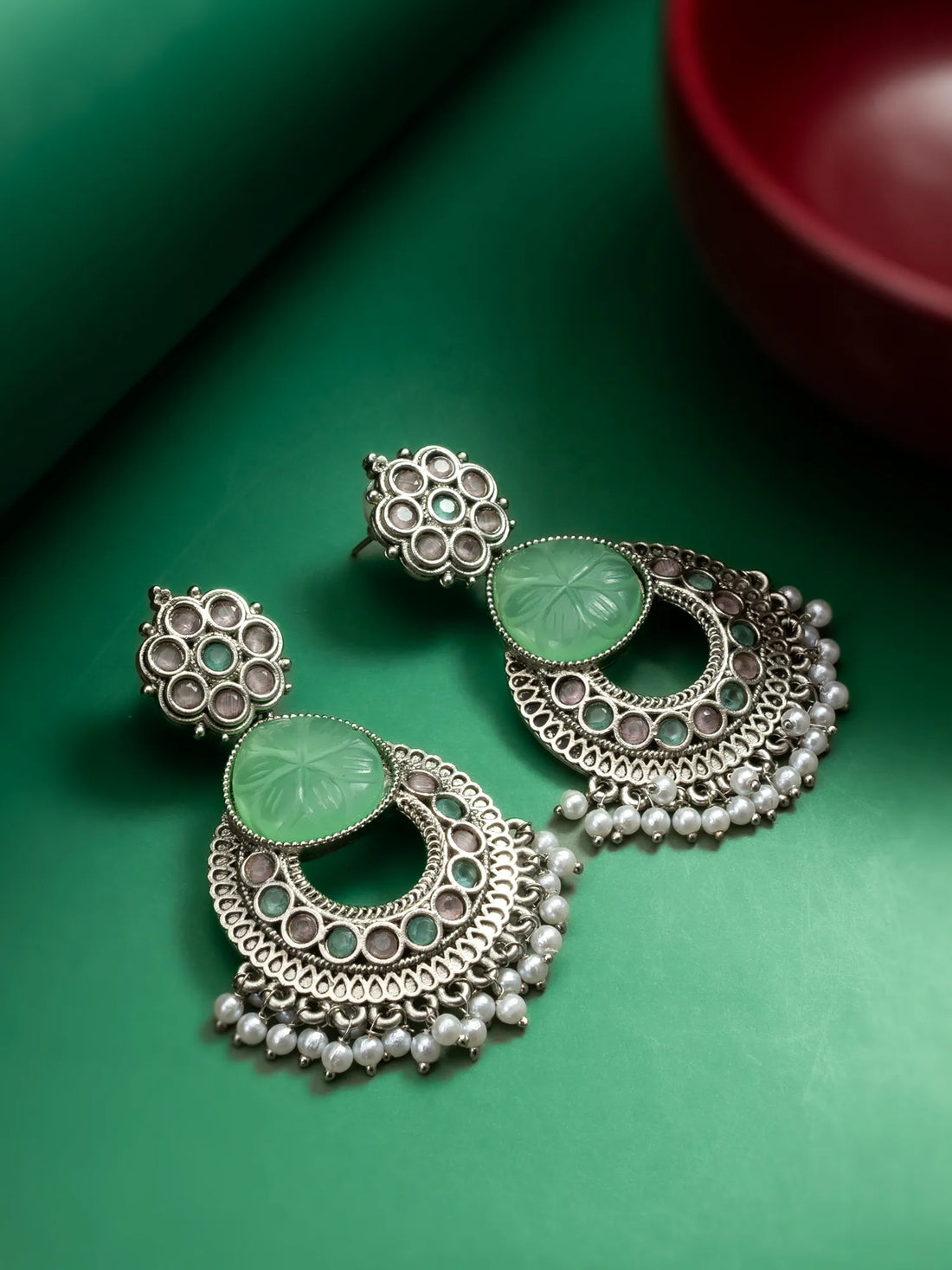 Oxidized Chandbali Earrings On A Green Background
