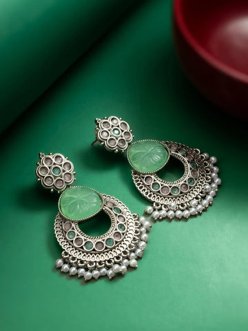 Oxidized Chandbali Earrings On A Green Background