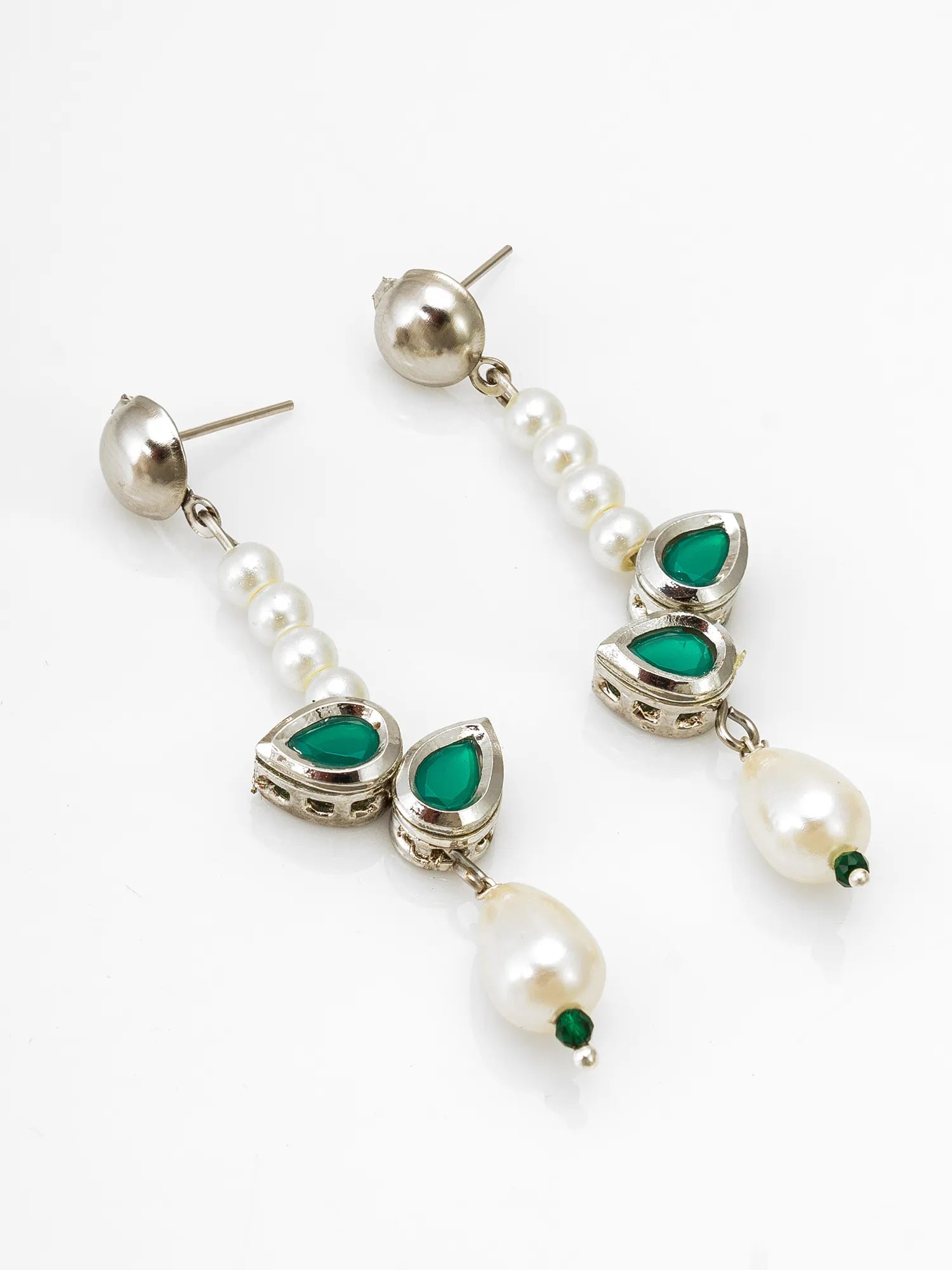 Pearl and emerald drop earrings on a white background