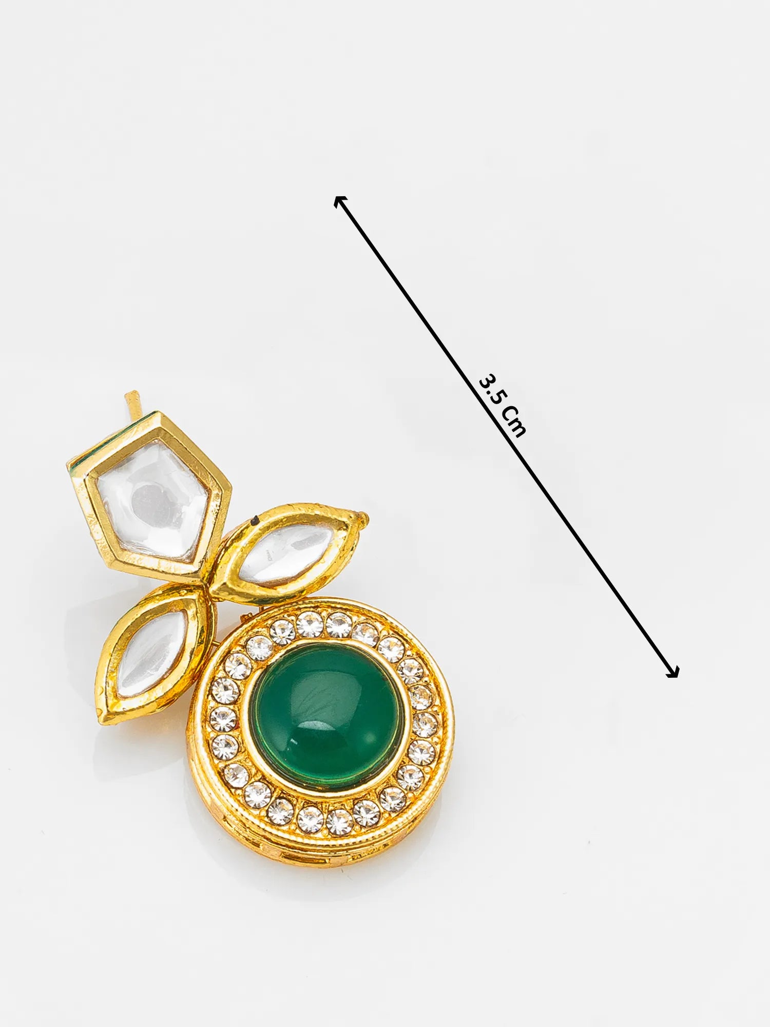 Gold pendant with a green gemstone and clear stones on a white background