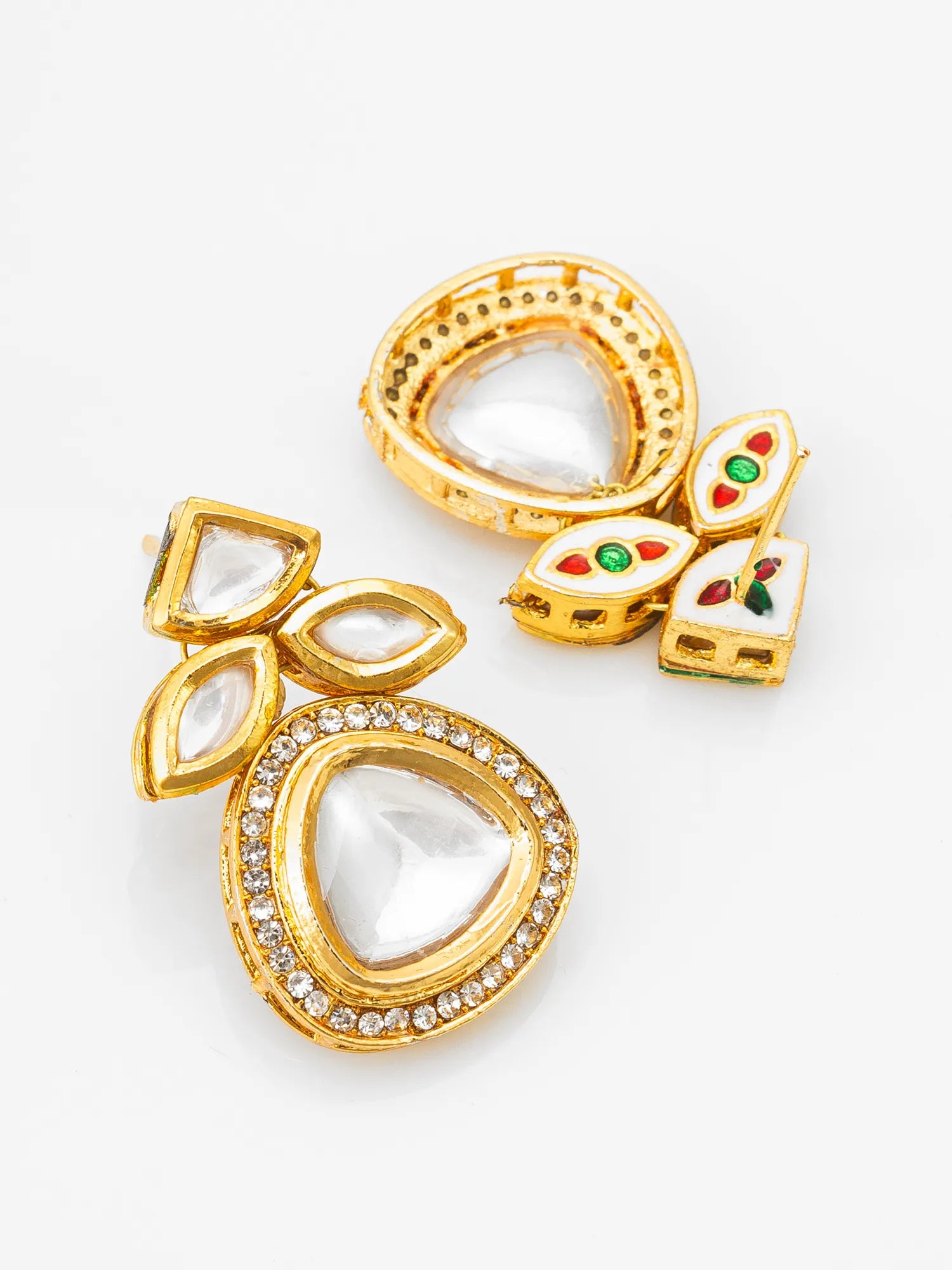 Gold earrings with gemstones on a white background