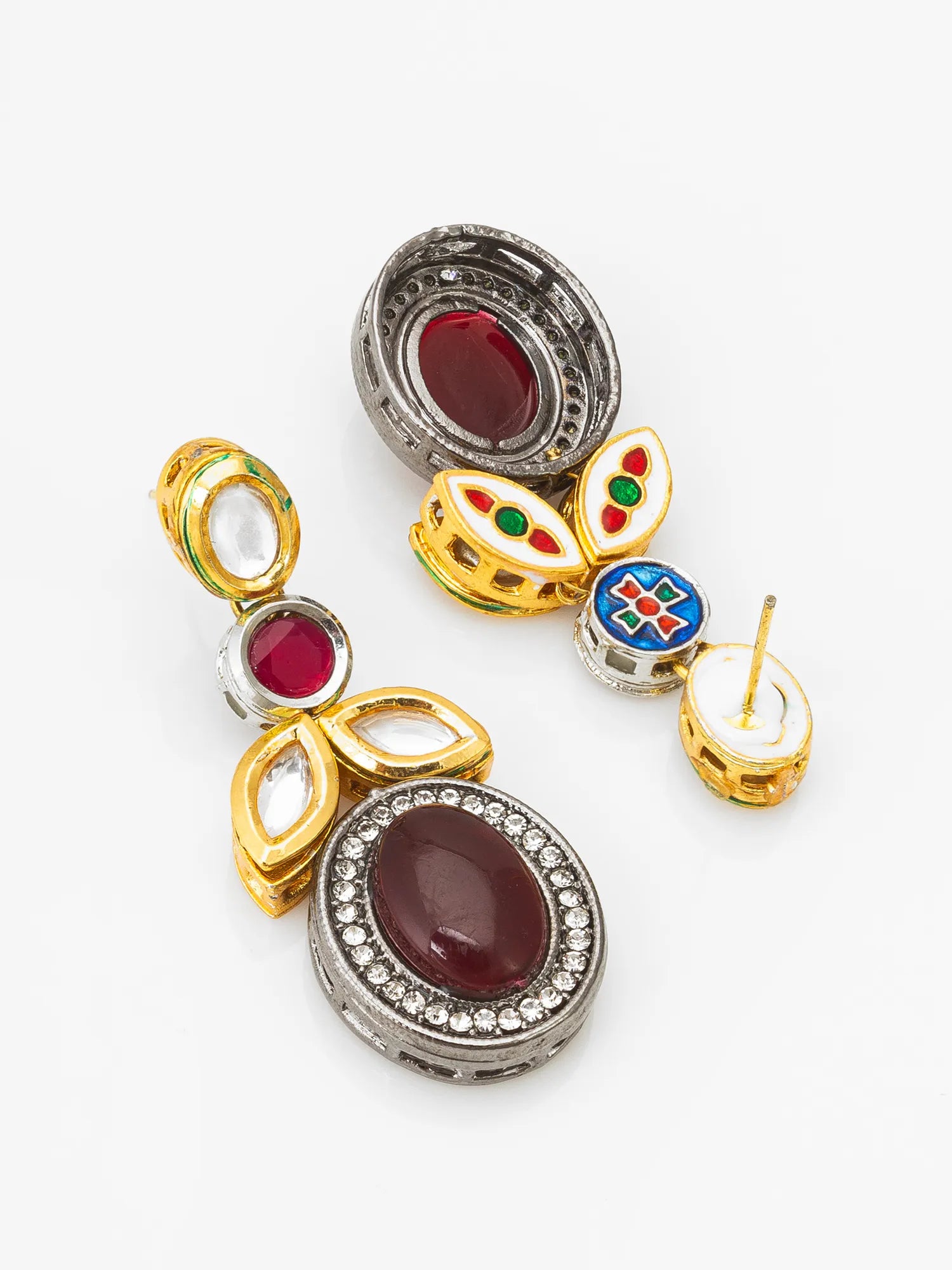 Set of gold and silver earrings with gemstones on a white background