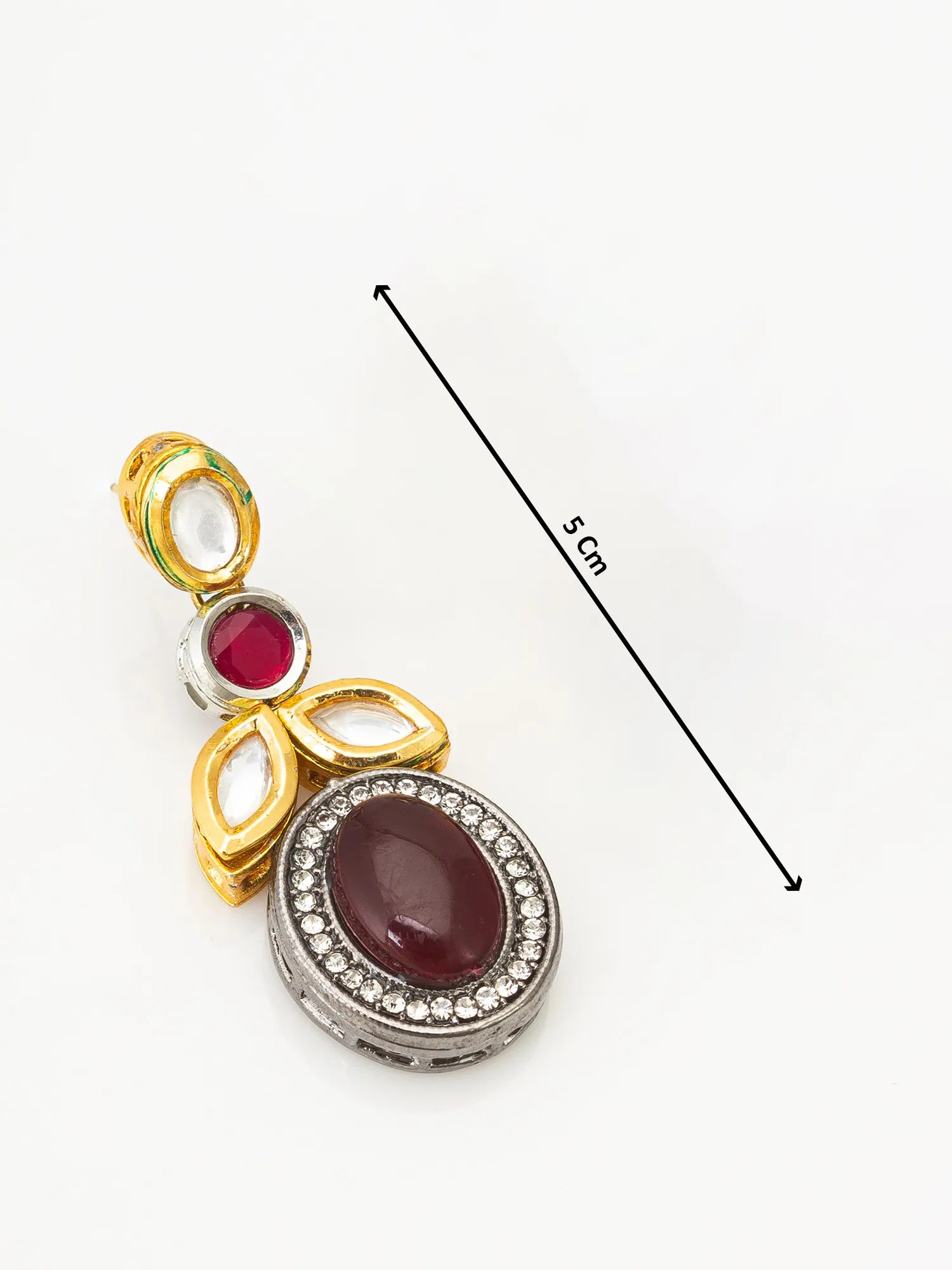 Jewelry pendant with red stone and gold accents on a white background