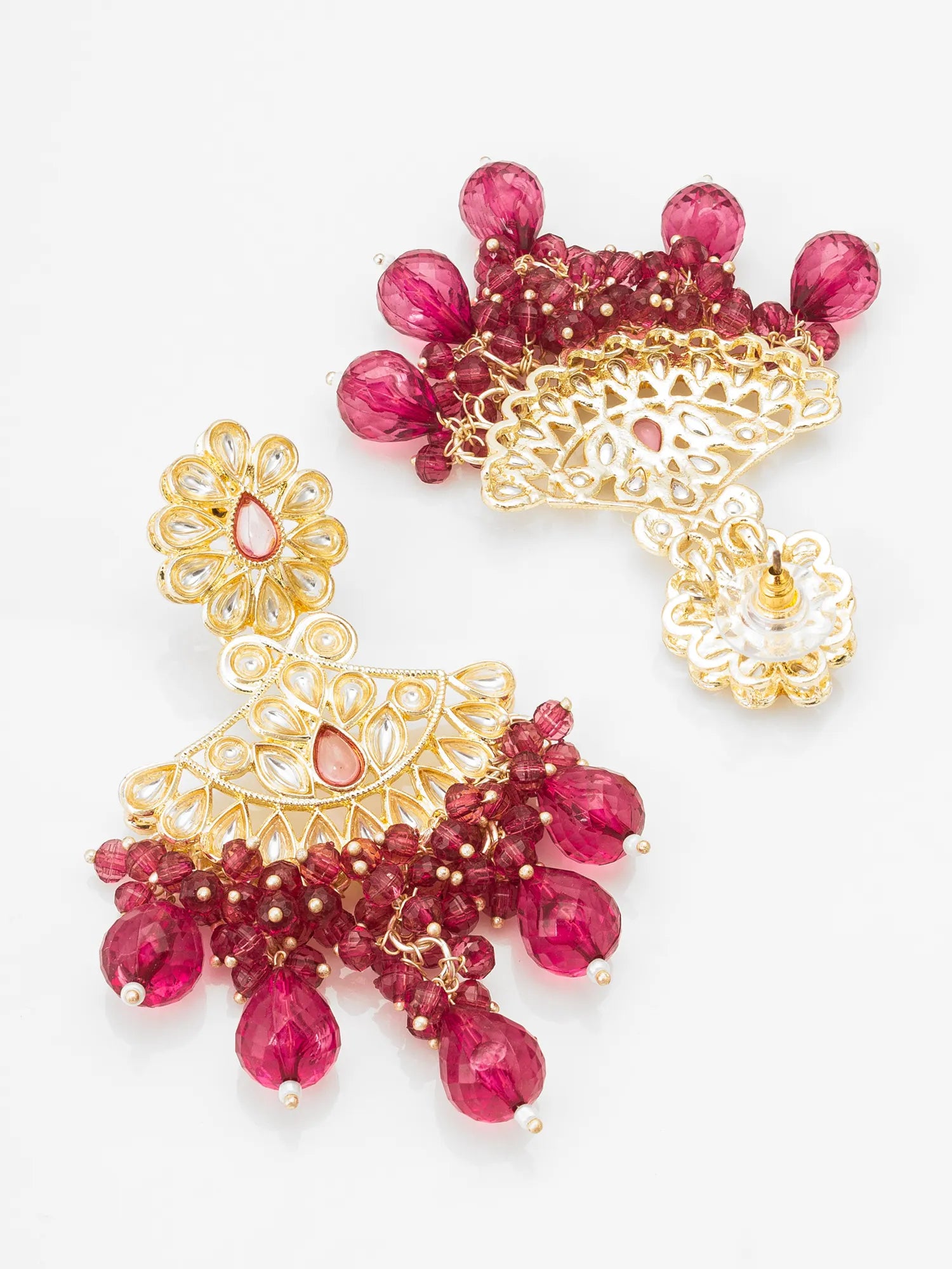 Gold and red beaded earrings on a white background
