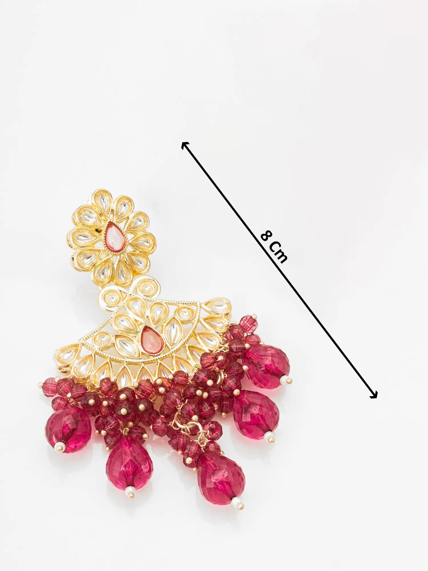 Gold and red gemstone earring with measurement label on a white background