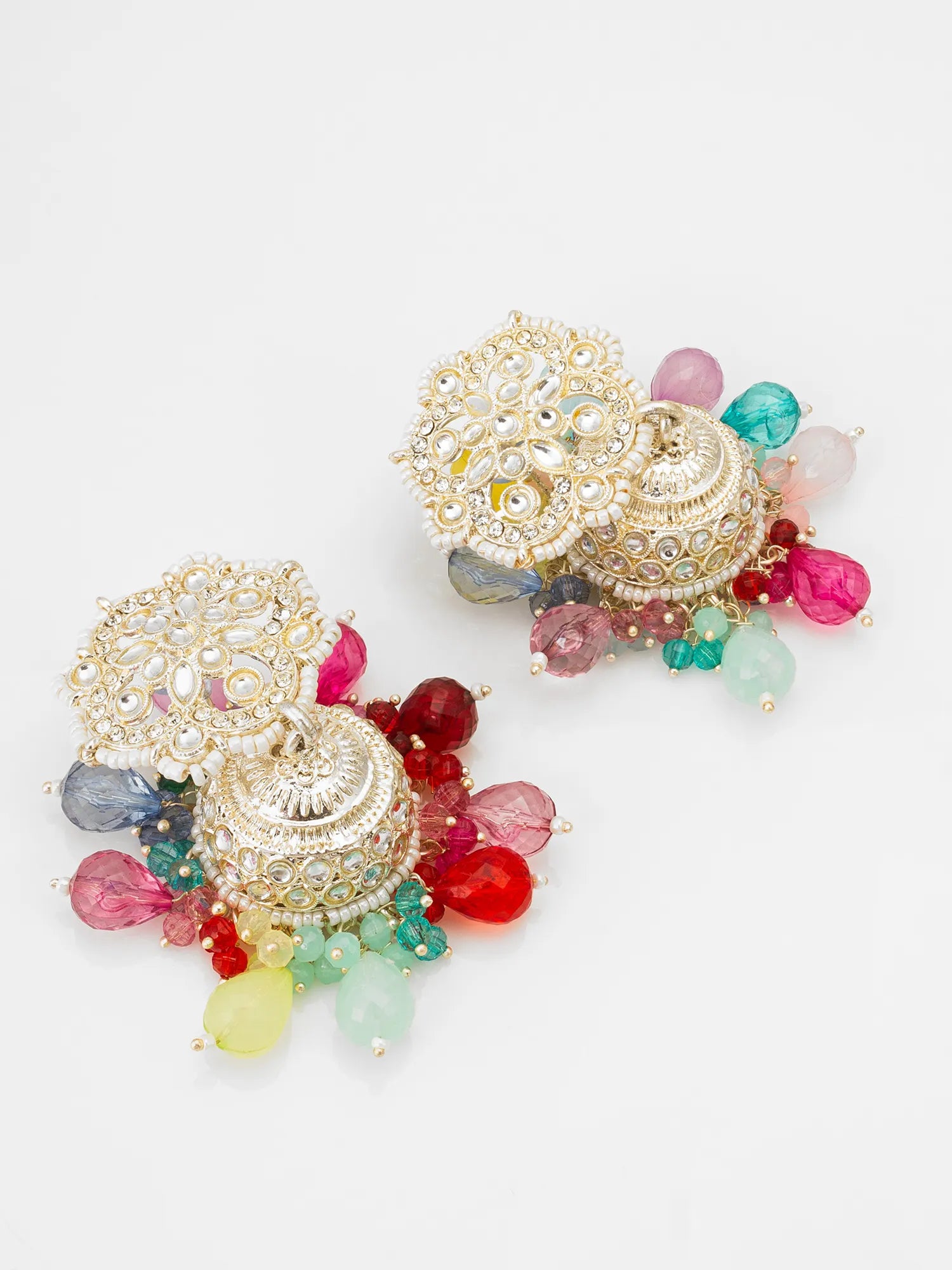 A pair of ornate Indian jhumka earrings with gold-toned filigree, clear stone embellishments, and dangling multicolored glass beads in pink, red, green, blue, and yellow on a white background.