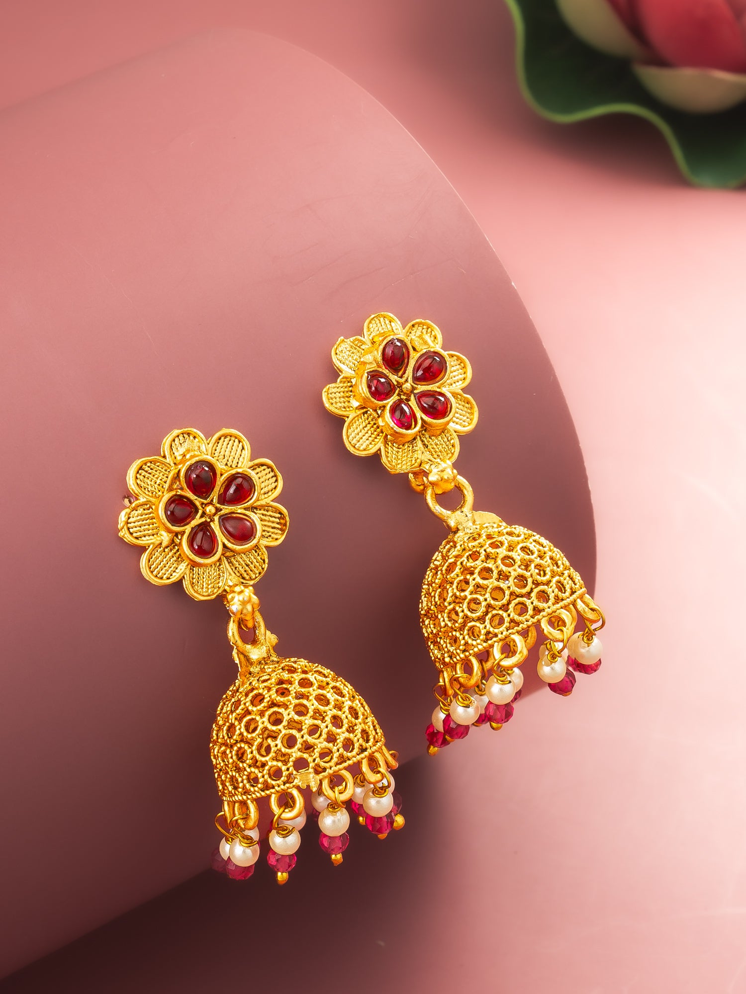 Aadita Gold Plated Floral Jhumka Earrings with Pink Stone Accents