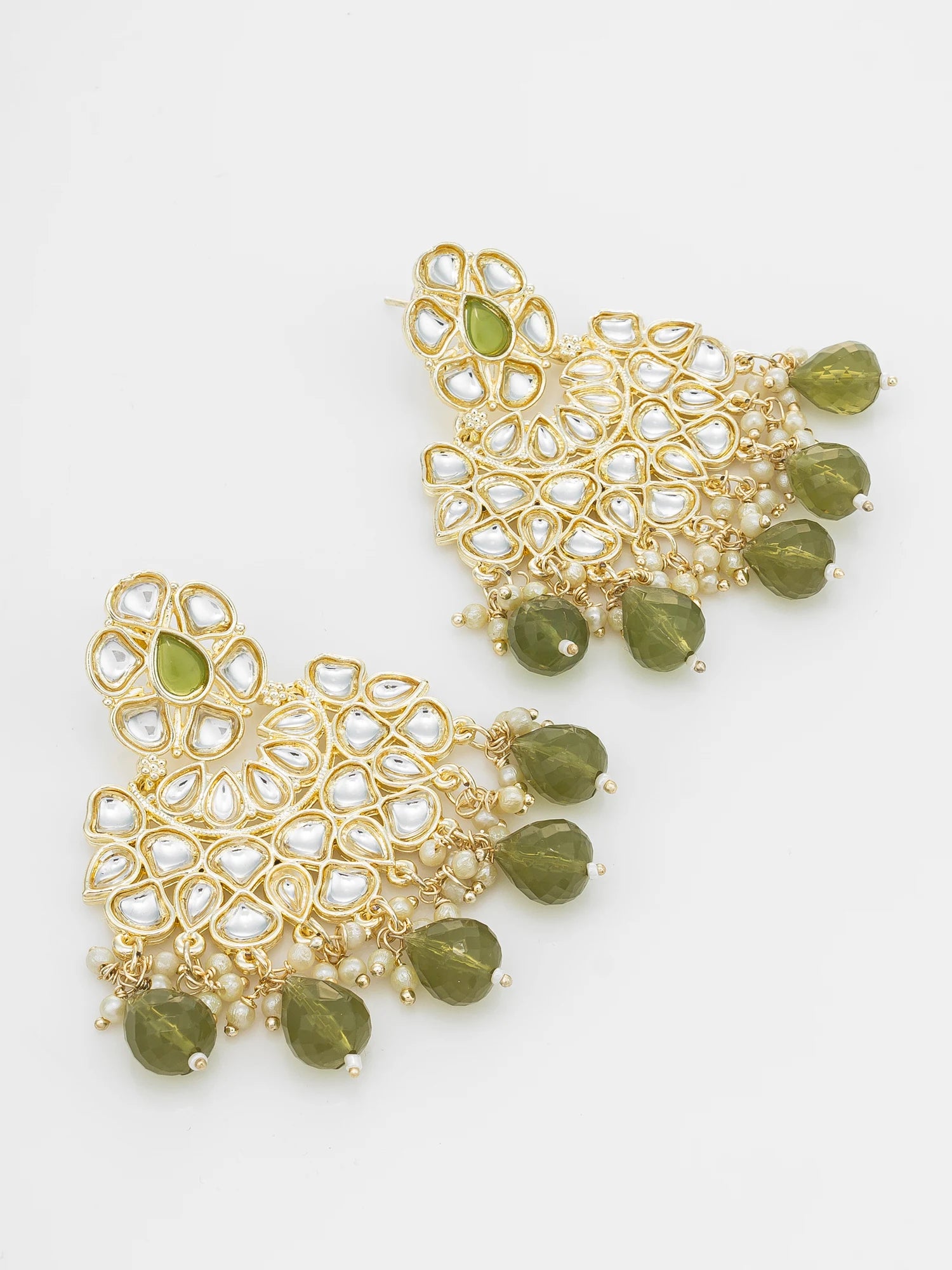 A pair of gold-toned chandelier earrings embellished with white faux pearls and green faceted beads, displayed on a clean white background.