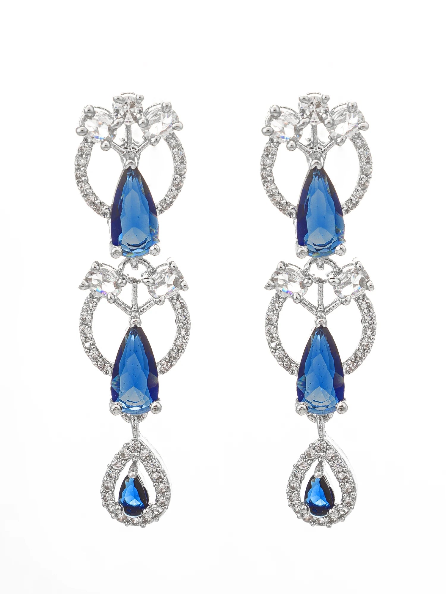 A pair of silver-tone drop earrings featuring faceted blue teardrop crystals and clear crystal accents, set against a plain white background.