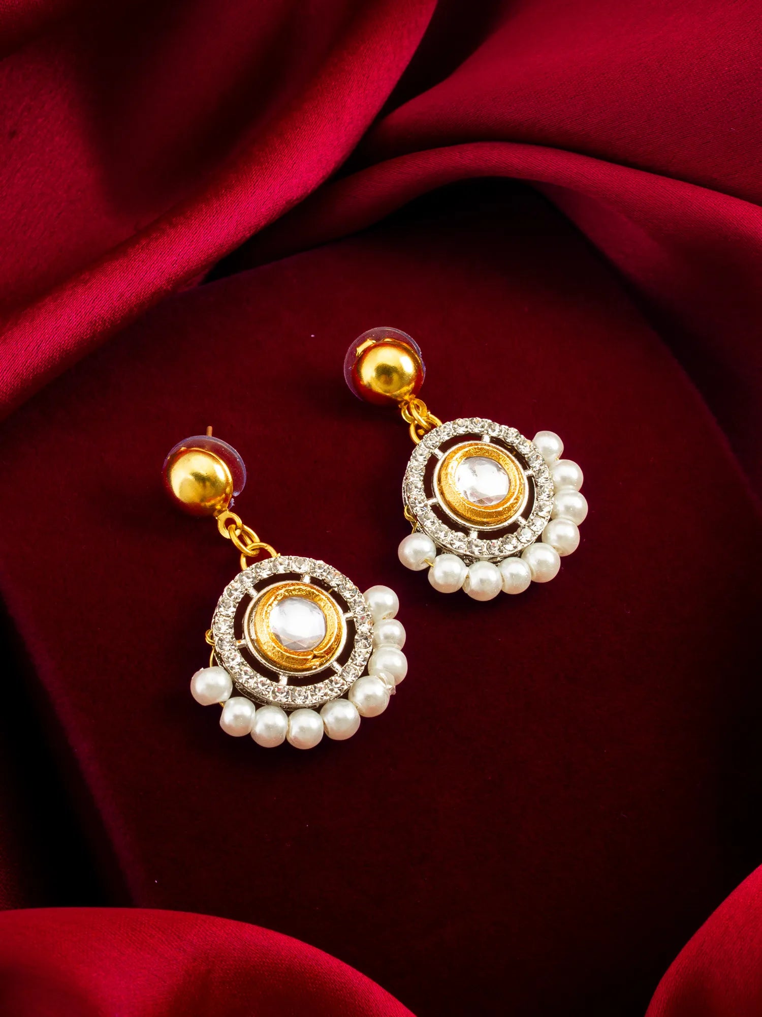 Round AD Stud Earrings With Pearl Border On A Red Background