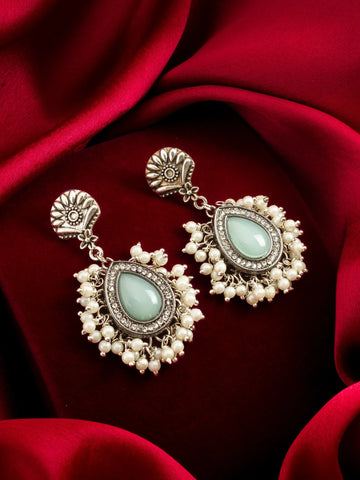 Mint Stone and Pearl Cluster Earrings On A Red Background