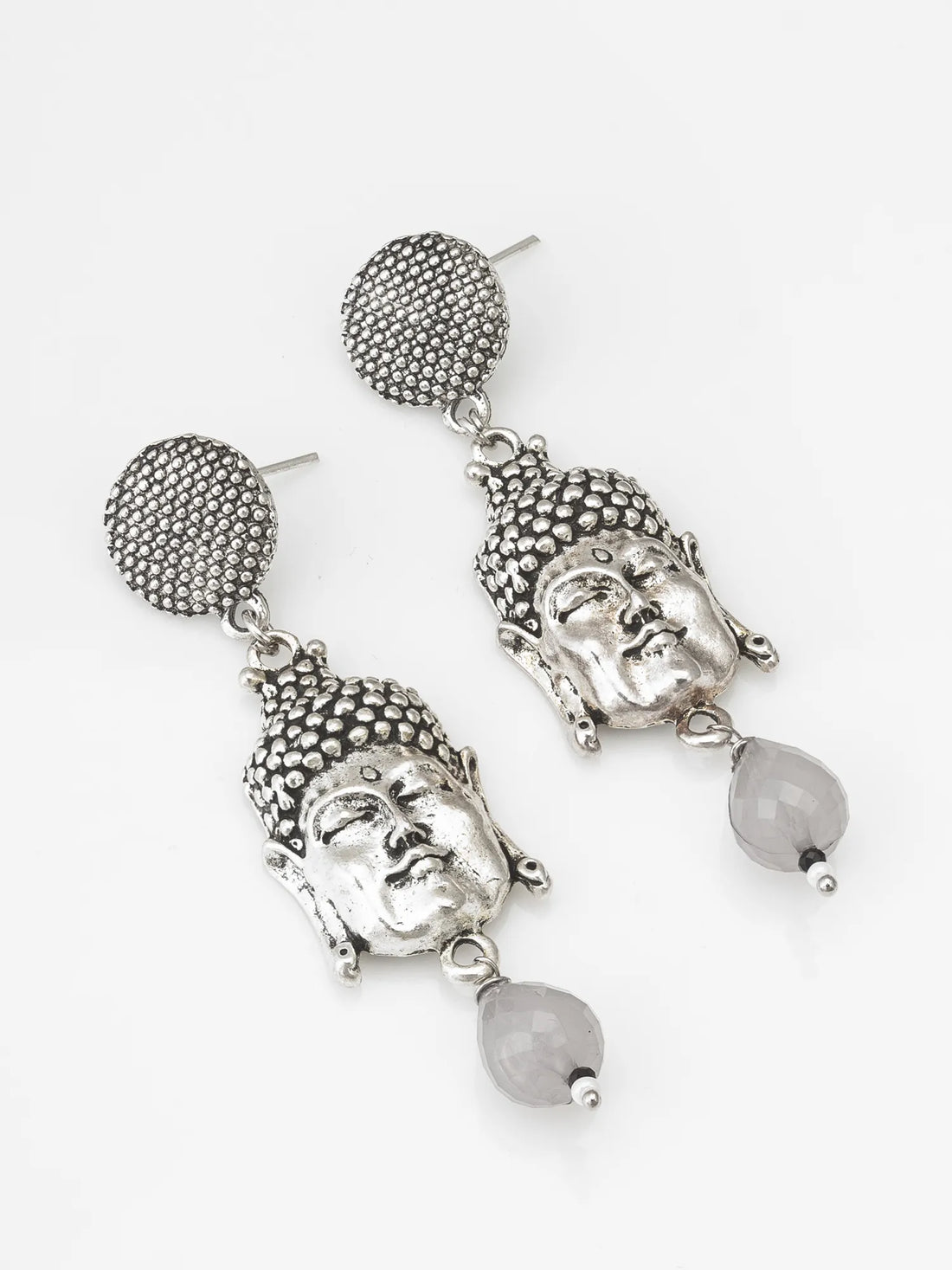 Silver Buddha Face Drop Earrings On A Background