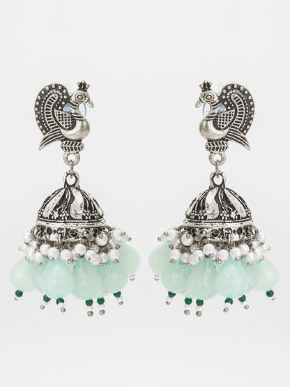 Mint Green Oxidized Jhumka Earrings On A White Background