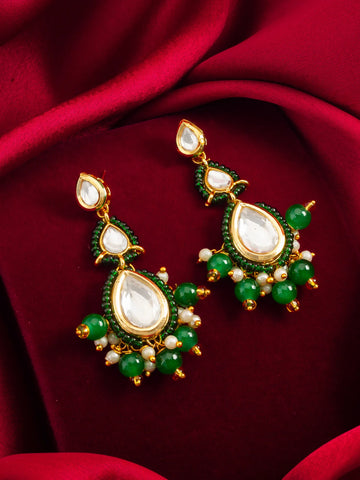 Gold-Toned Kundan Earrings On A Red Background