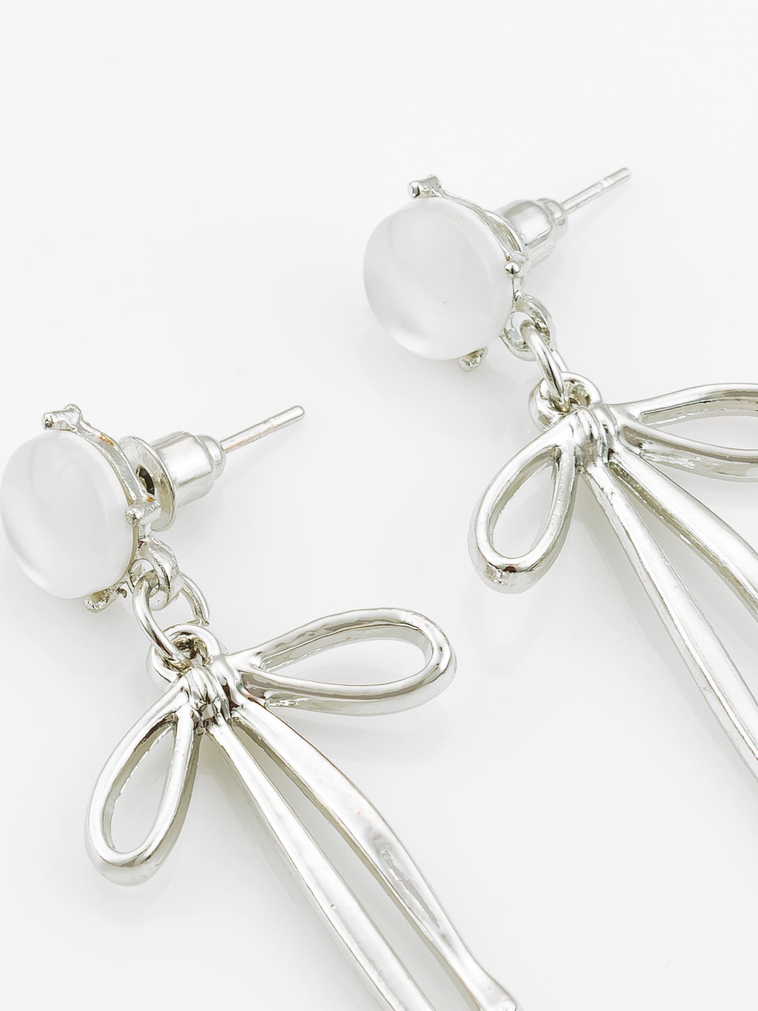 Aadita Silver Plated Ribbon Design Earrings with Frosted Studs