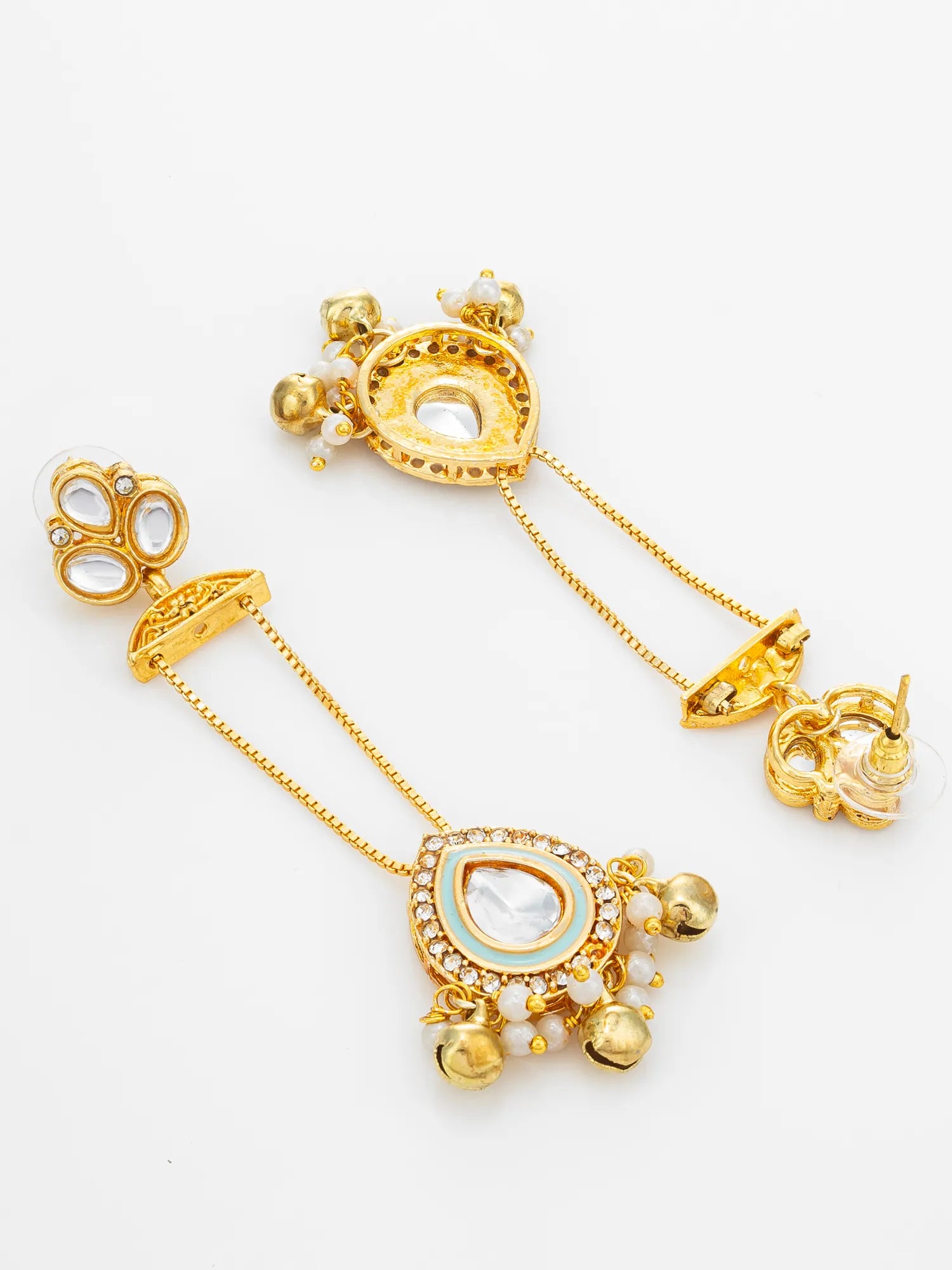A pair of gold-toned traditional Indian dangle earrings with white stone accents and small gold bells, displayed on a clean white background.