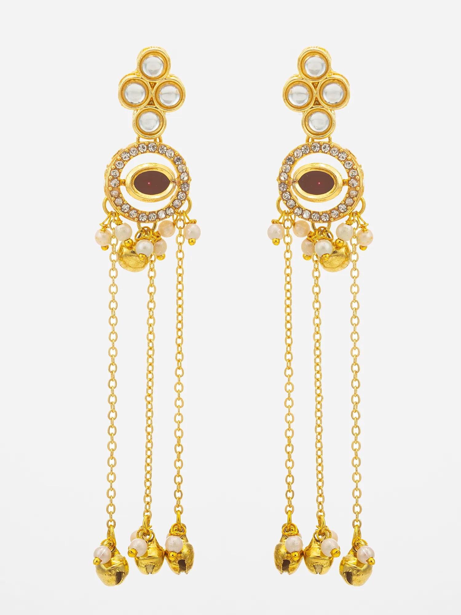 A pair of gold-toned Indian jhumka earrings with white pearl-like beads, clear rhinestones, and a central brown enamel inlay, shown against a light gray background.