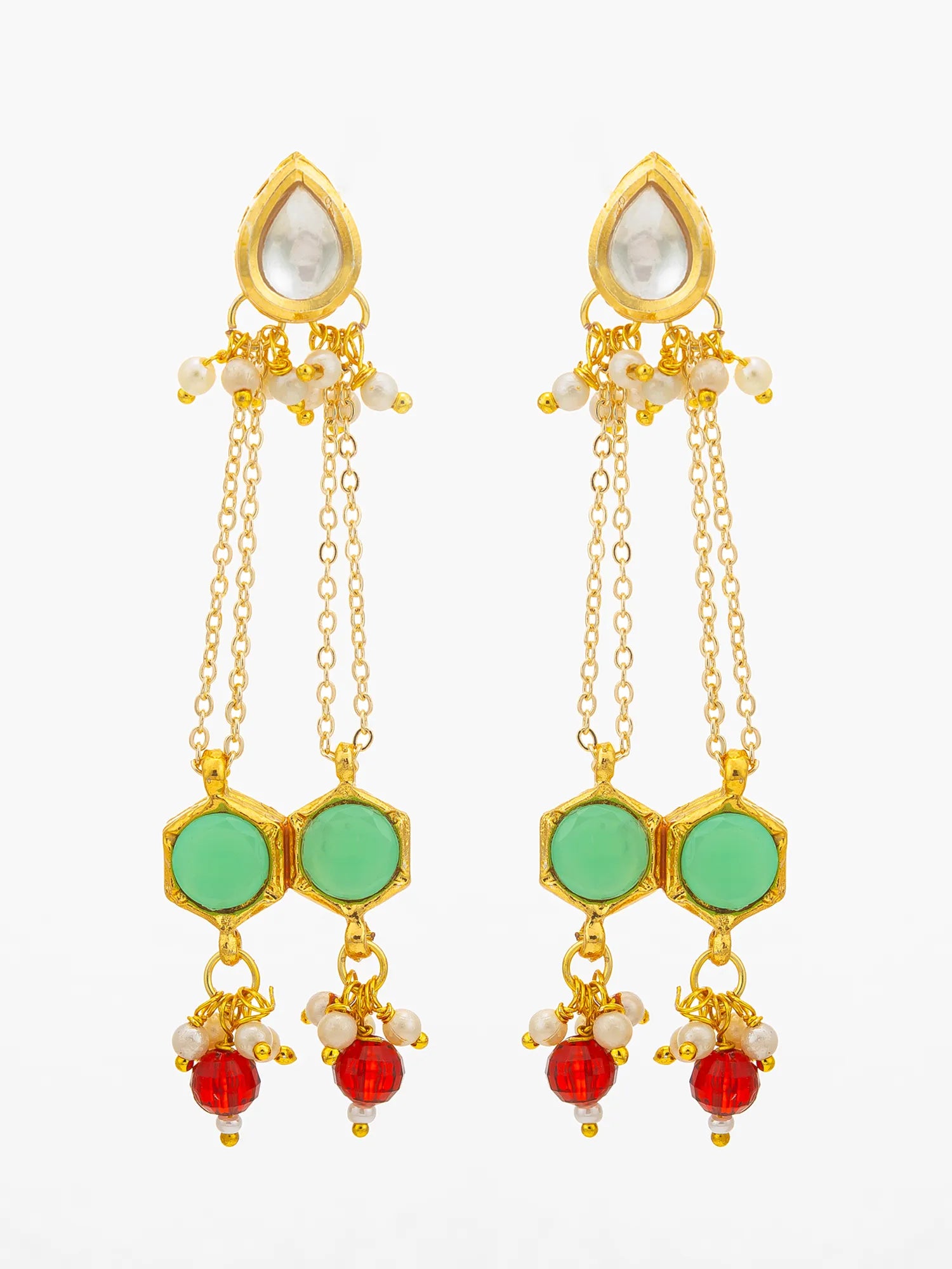 A pair of gold-toned Indian style dangle earrings featuring light green hexagonal stones, white pearl-like beads, and red bead drops, set against a plain white background.