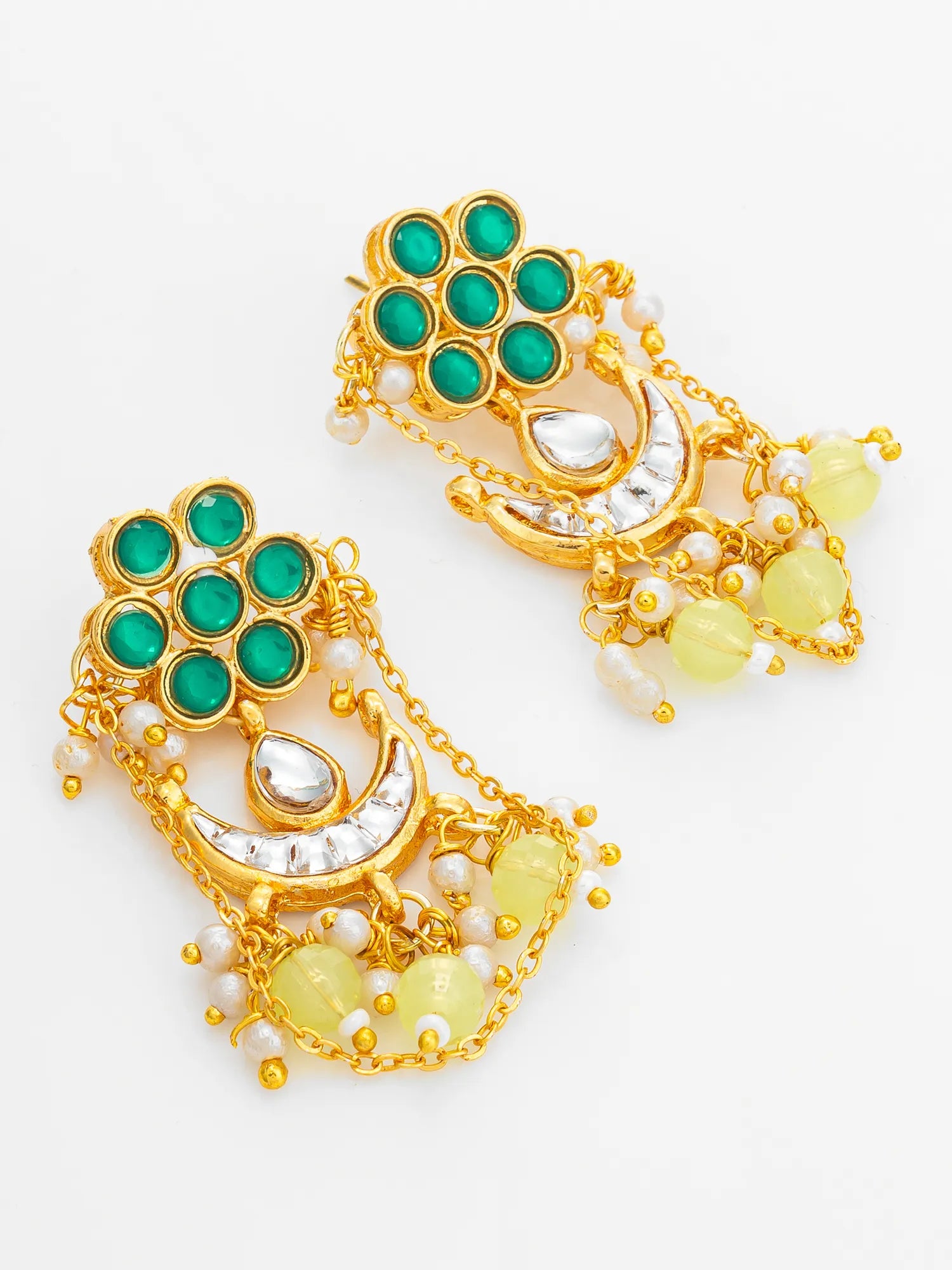 A pair of gold-toned Indian style dangle earrings featuring green stones, white pearl-like beads, and pale yellow bead drops, displayed on a clean white background.