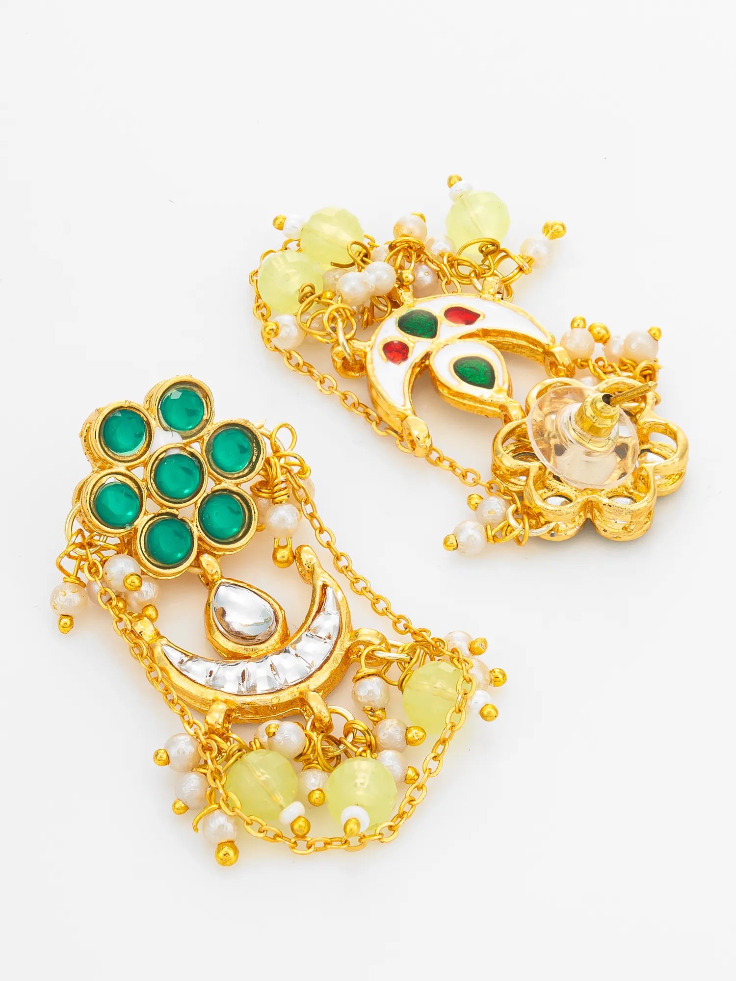 A pair of ornate gold-toned Indian jhumka earrings decorated with green stones, white faux pearls, and pale yellow beads on a clean white background.