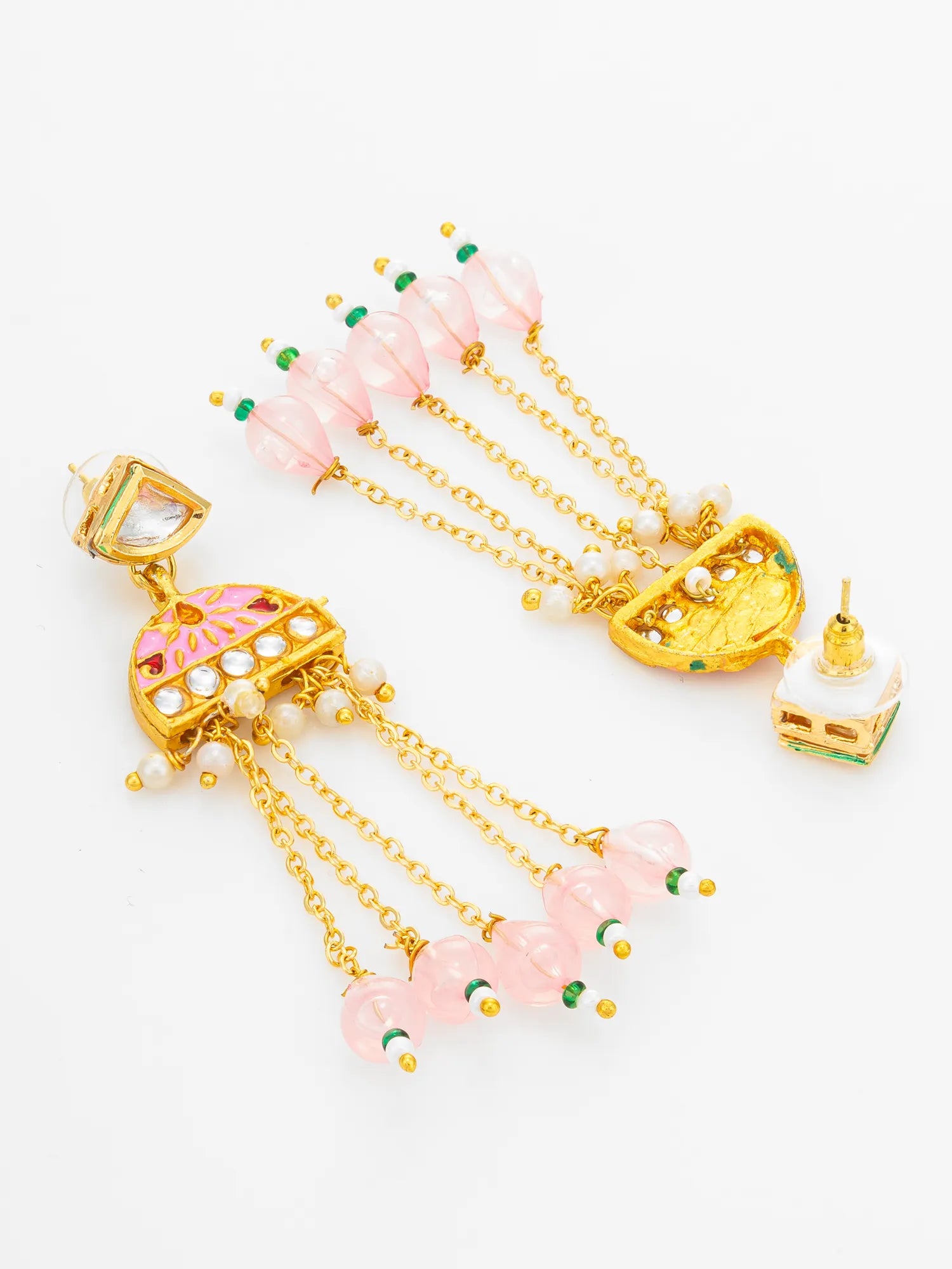 A pair of gold-plated Indian jhumka earrings decorated with pink glass beads, white stones, and small green accents, displayed on a clean white background.