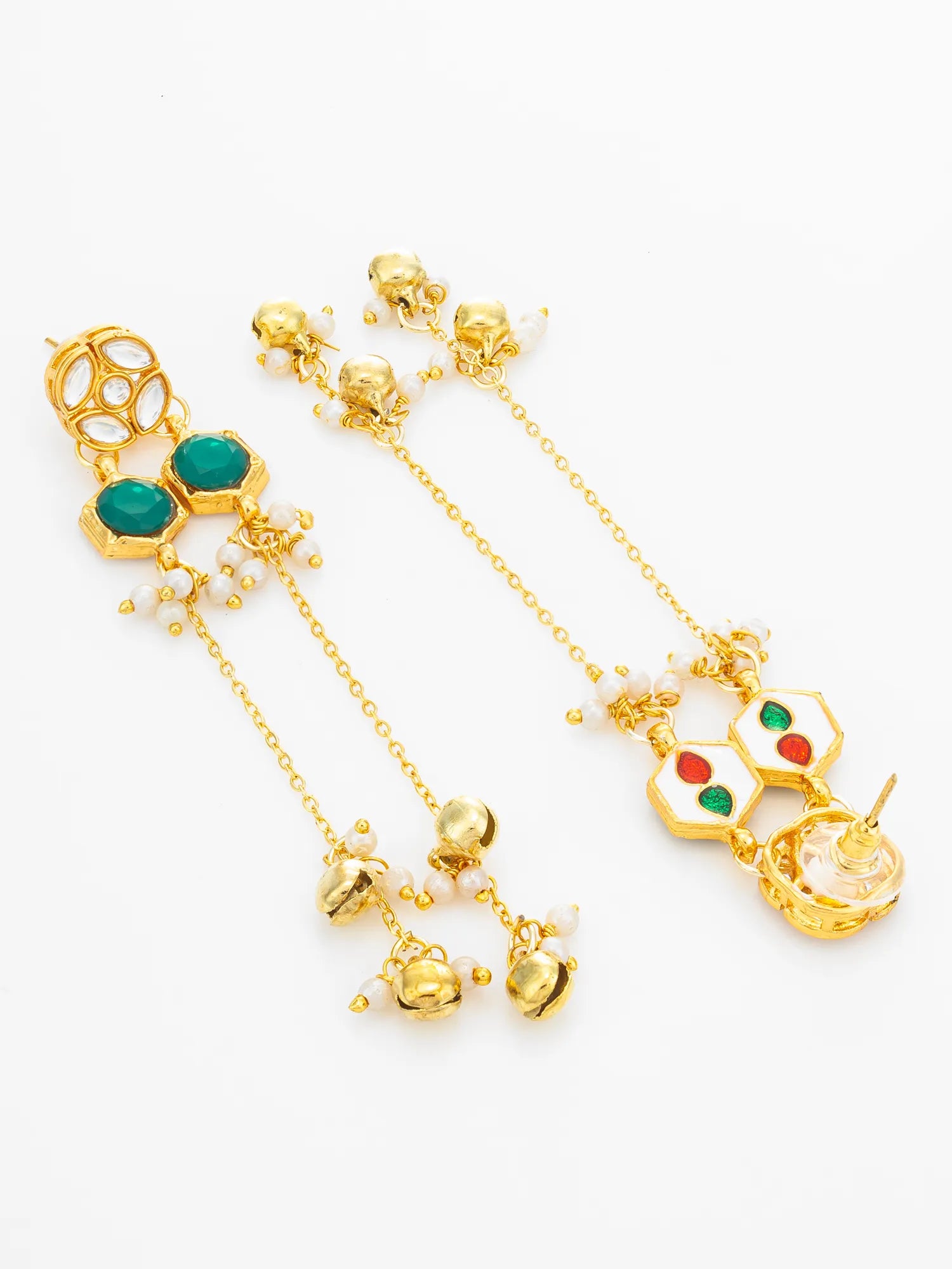 Gold-toned traditional Indian earrings with green and red inlaid stones, white pearl-like beads, and dangling gold charms on a white background.