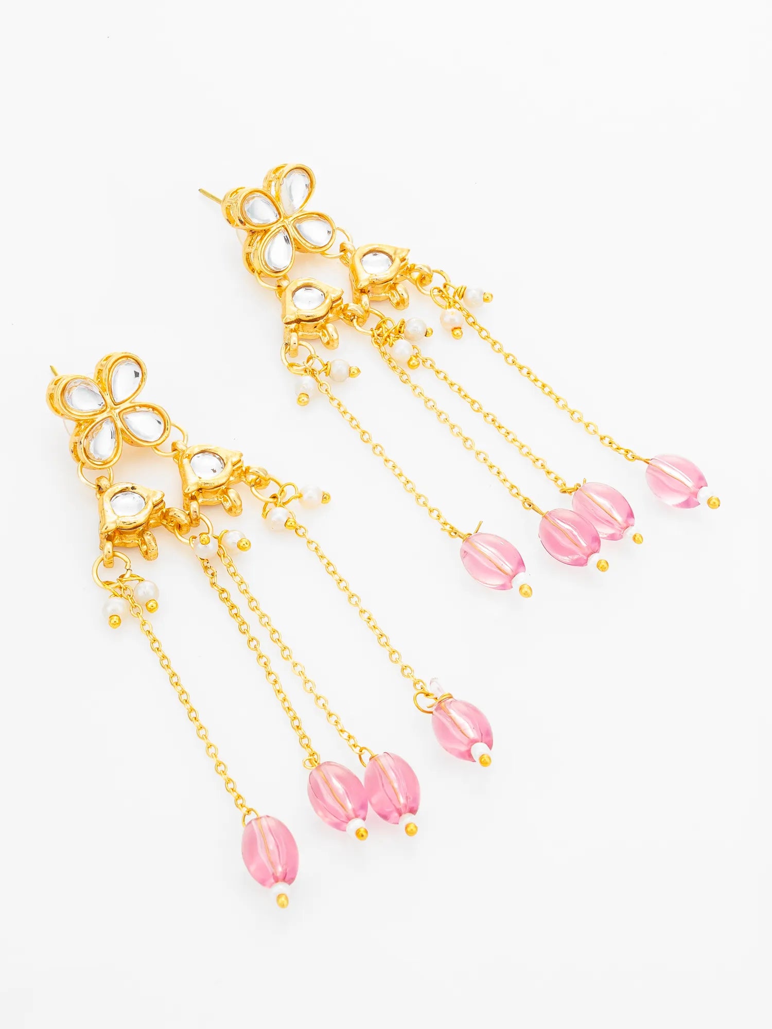 A pair of gold-toned dangle earrings with floral clusters, clear rhinestone-like accents, and multiple dangling pink bead chains on a plain white background.
