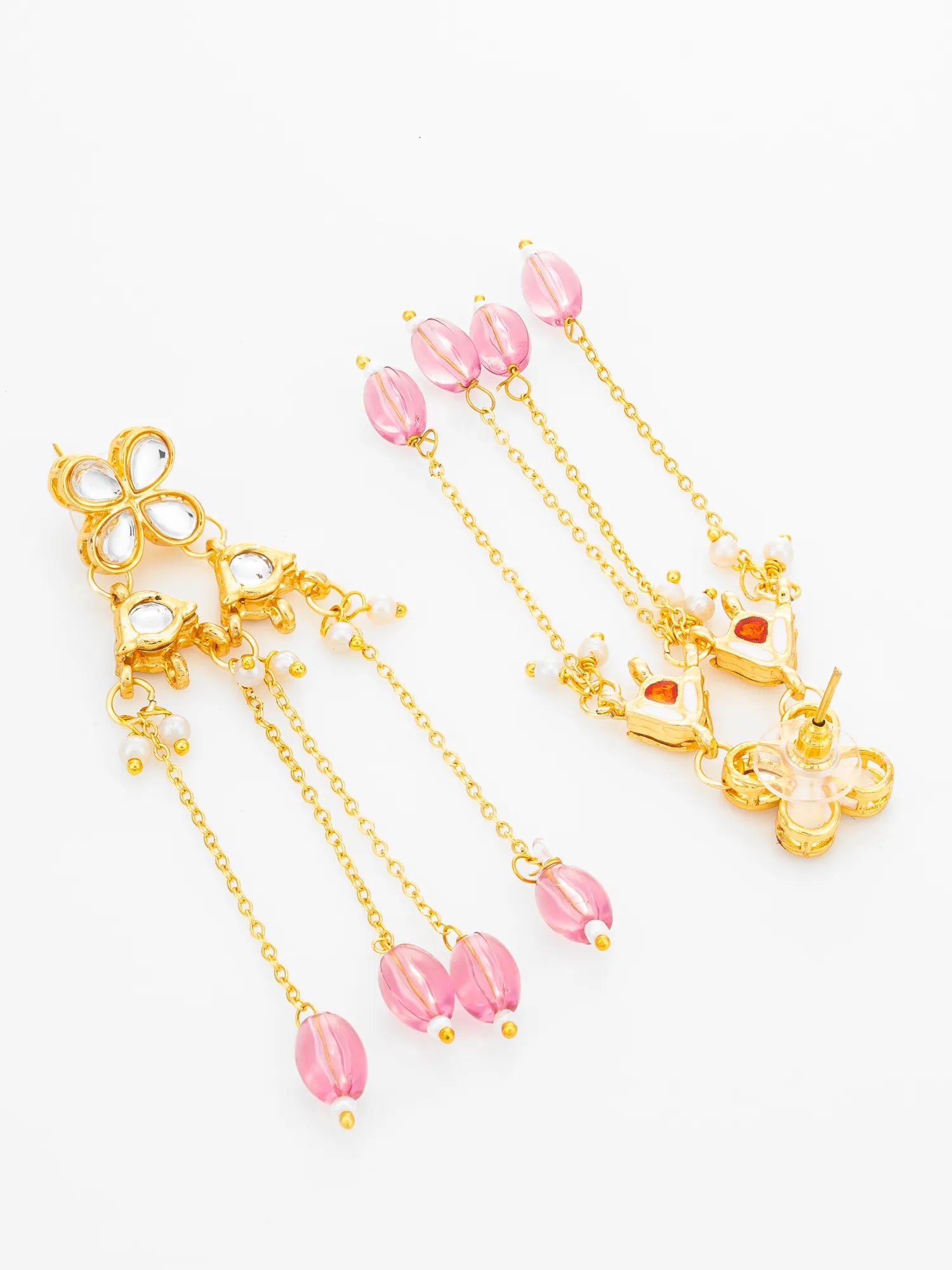 A pair of gold-toned traditional Indian earrings with dangling chains, pink faceted beads, and clear stone accents, displayed on a clean white background.