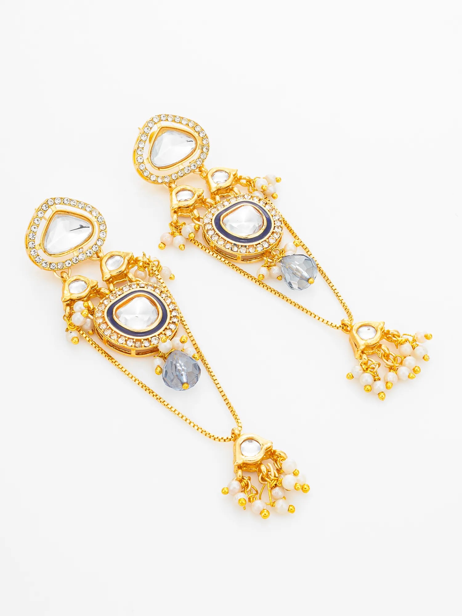 A pair of gold-toned Indian style dangle earrings with heart-shaped clear crystals, blue enamel accents, and small pearl-like beads, displayed on a clean white background.