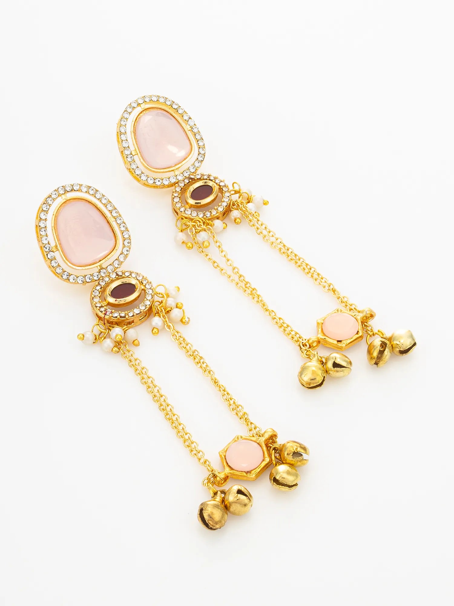 A pair of gold-plated dangle earrings featuring oval pale pink stones, clear rhinestone borders, small gold beads, and dangling bell charms, set against a plain white background.