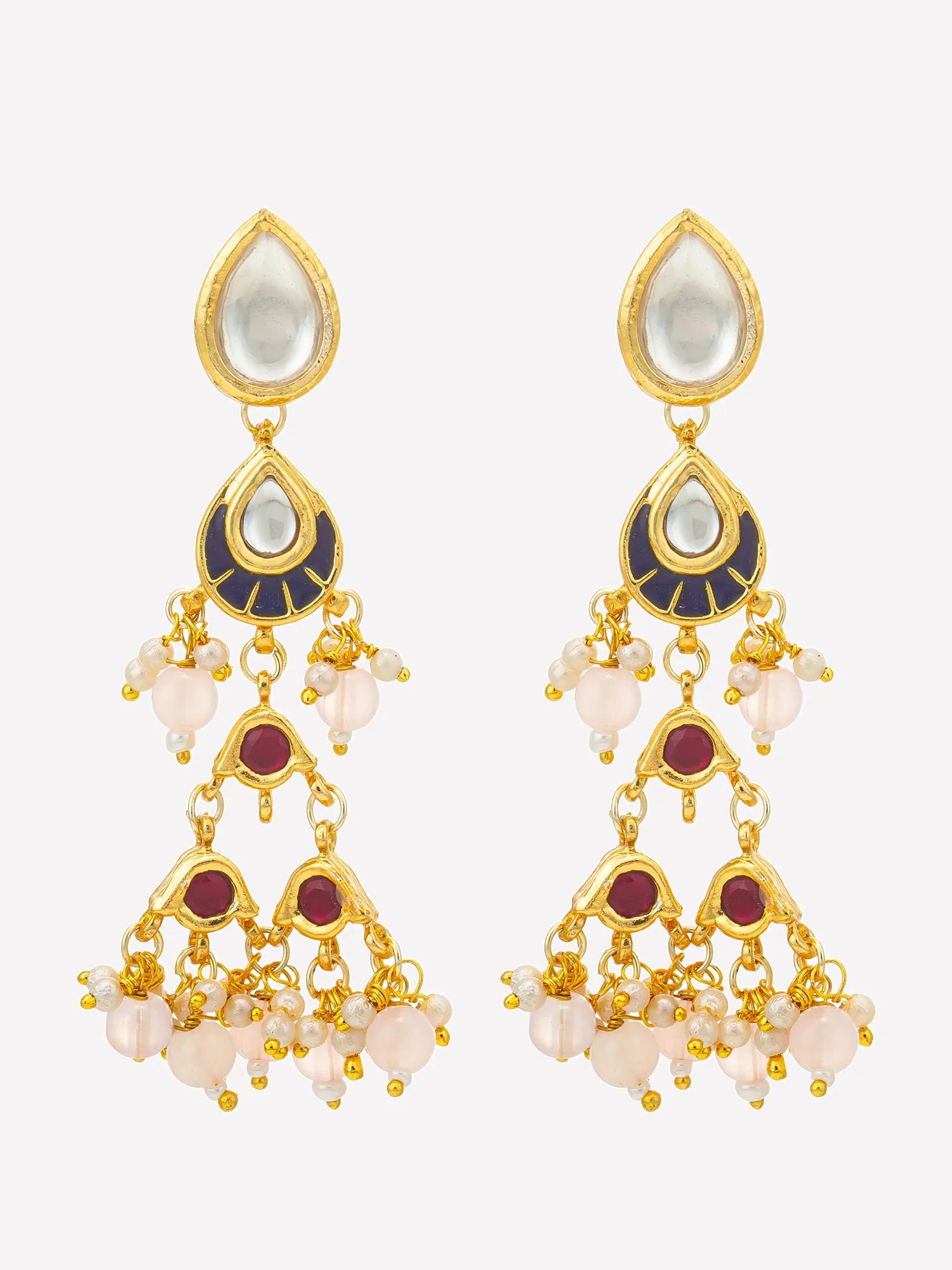 A pair of gold-plated Indian-style dangle earrings with white teardrop-shaped stones, dark blue enamel accents, and dangling light pink beads, shown against a light gray background.