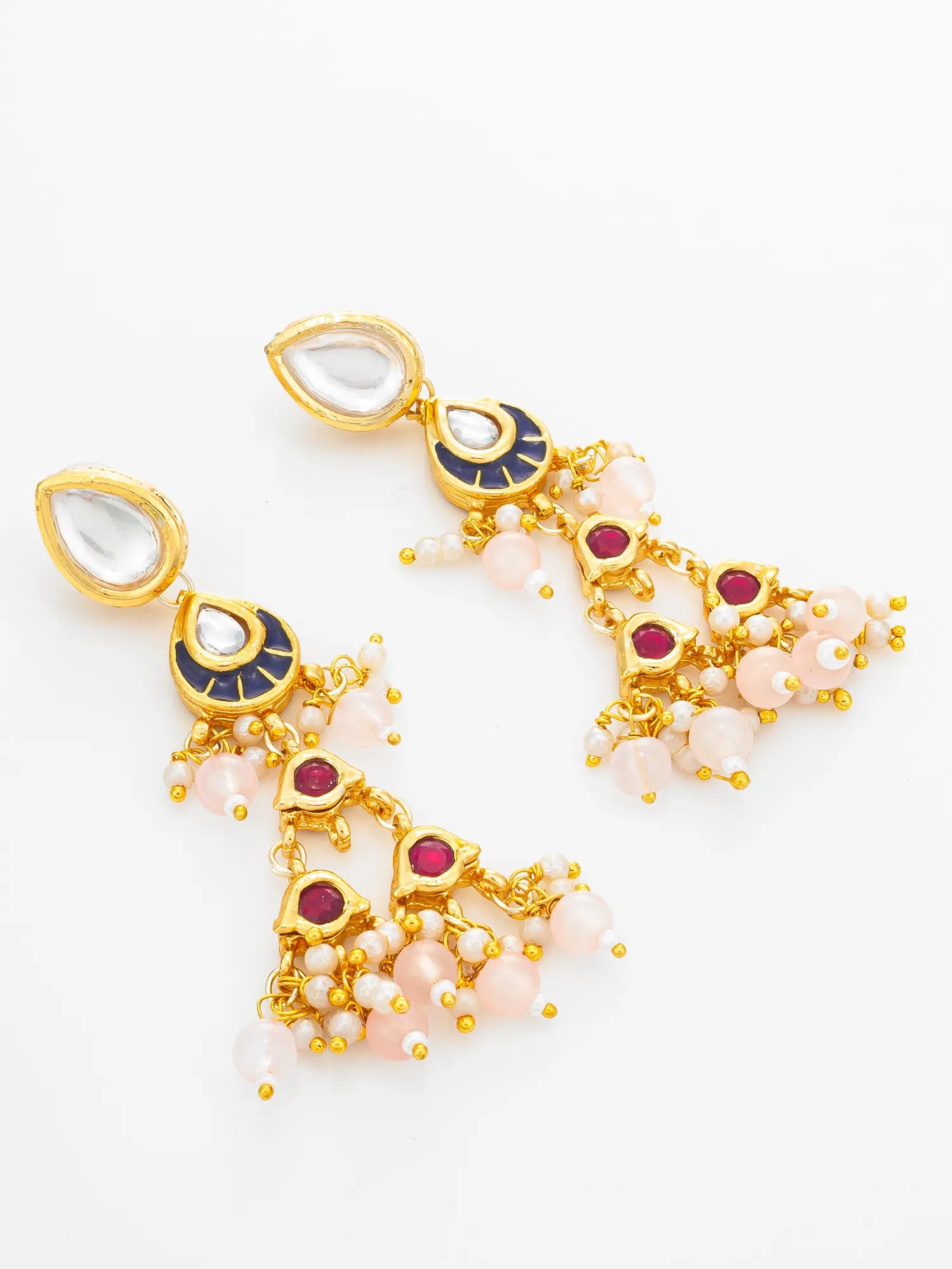 A pair of gold-plated Indian jhumka earrings with white teardrop stones, pink and white beads, and red gemstone accents, displayed on a clean white background.