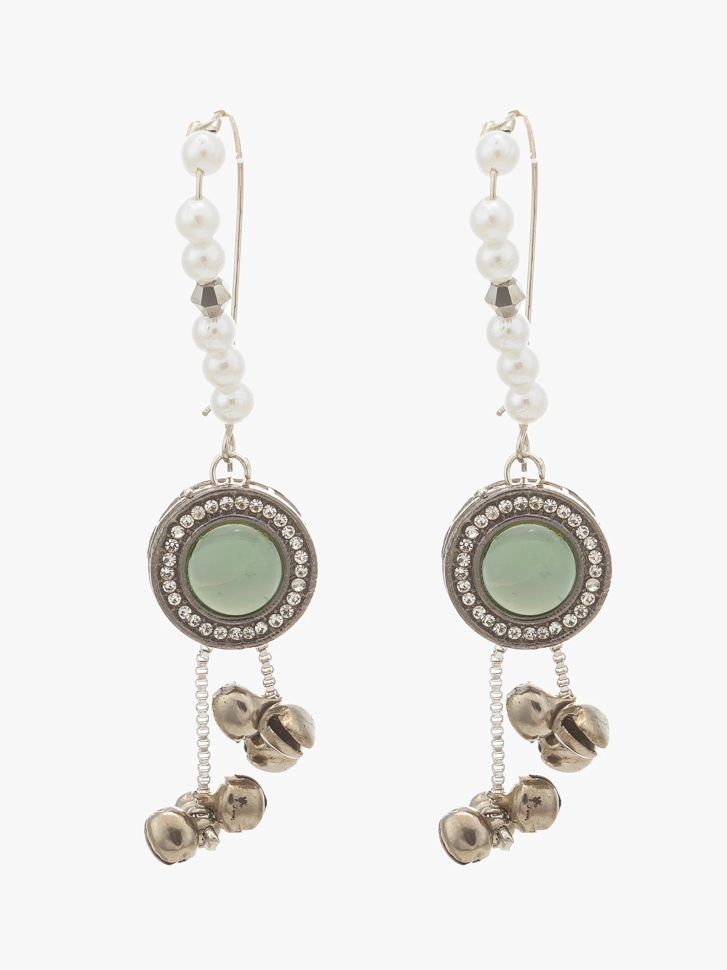 A pair of bohemian-style dangle earrings featuring white faux pearls, silver-tone metal, a light green circular stone, and dangling bell charms, shown against a plain light gray background.