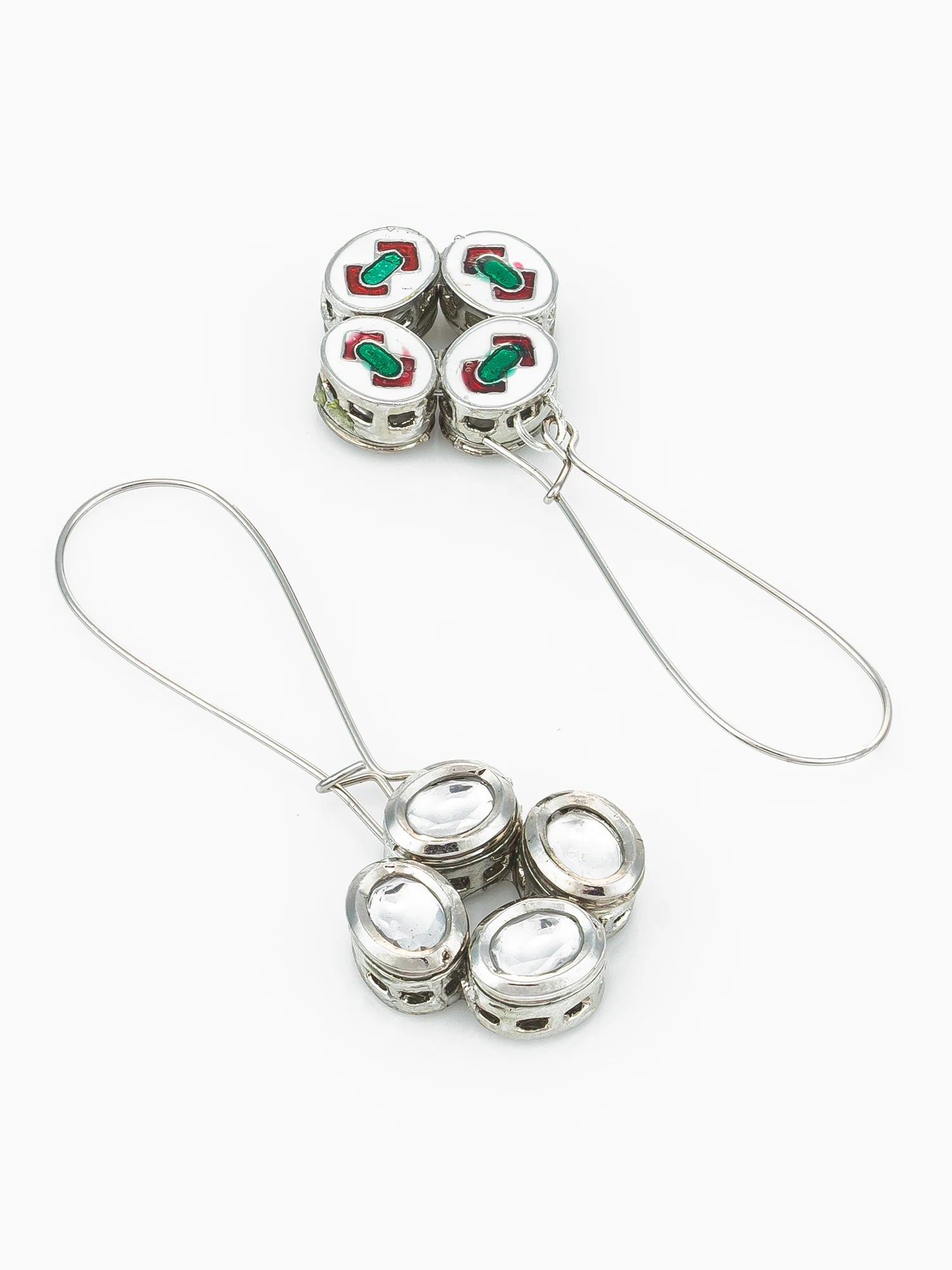 A pair of silver-toned drop earrings with four round charm beads on each drop, featuring white enamel sections with red and green lettering, set against a plain white background.